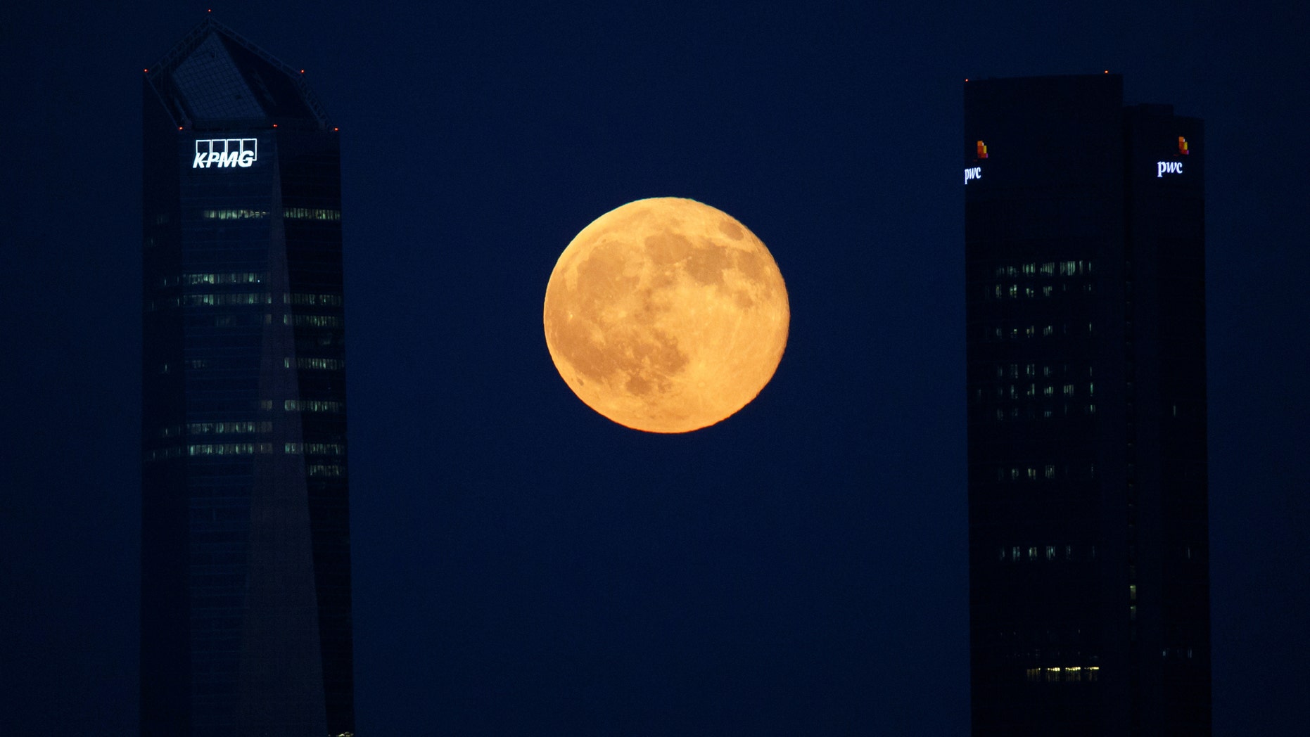 File photo: The full moon rises between buildings in the Four Towers business district in Madrid, Spain, July 9, 2017. (REUTERS/Paul Hanna)