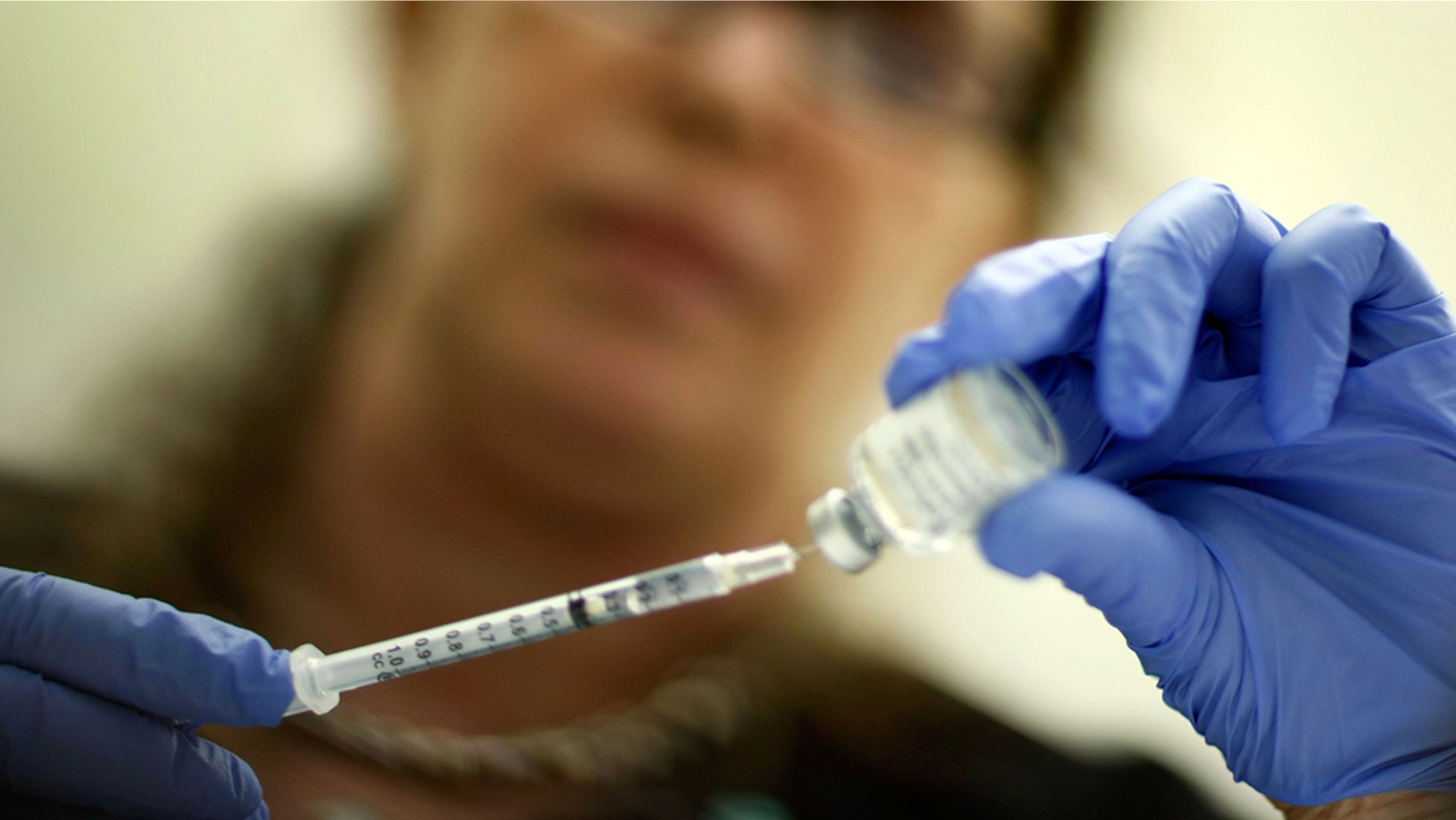 MIAMI - NOVEMBER 03: Marina Spelzini, a registered nurse, measures out an H1N1 vaccine shot at the Miami Dade County Health Department downtown clinic on November 3, 2009 in Miami, Florida. Unlike other parts of the country which are experiencing long lines and shortages of the vaccine, South Florida is not having this problem. The Miami-Dade County Health Department received 195,000 doses of the vaccine but has only given out about 10,100. Broward County has 52,000 doses on hand and has administered about 10,000 doses. (Photo by Joe Raedle/Getty Images)