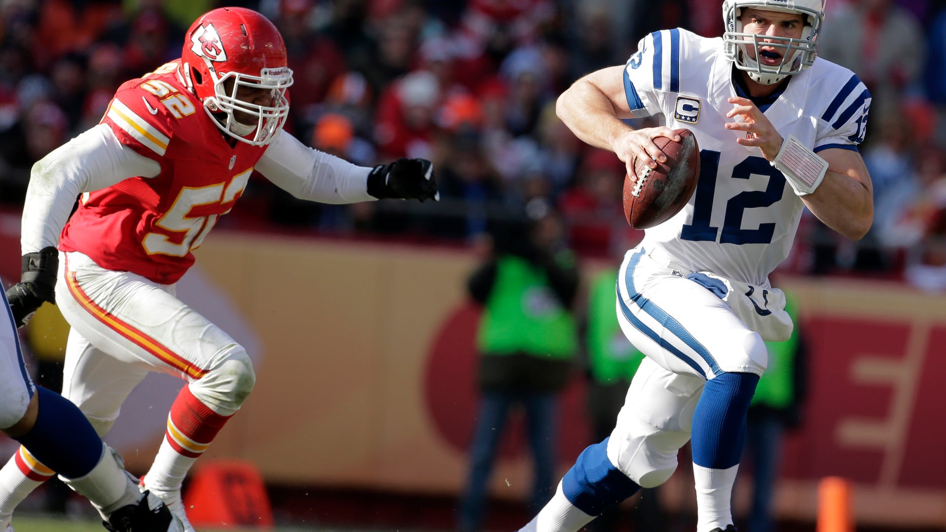 Indianapolis Colts quarterback Andrew Luck, right, scrambles away from Kansas City Chiefs inside linebacker Brandon Siler during the first half of an NFL football game on Sunday, Dec. 23, 2012, in Kansas City, Mo. (AP Photo/Charlie Riedel)