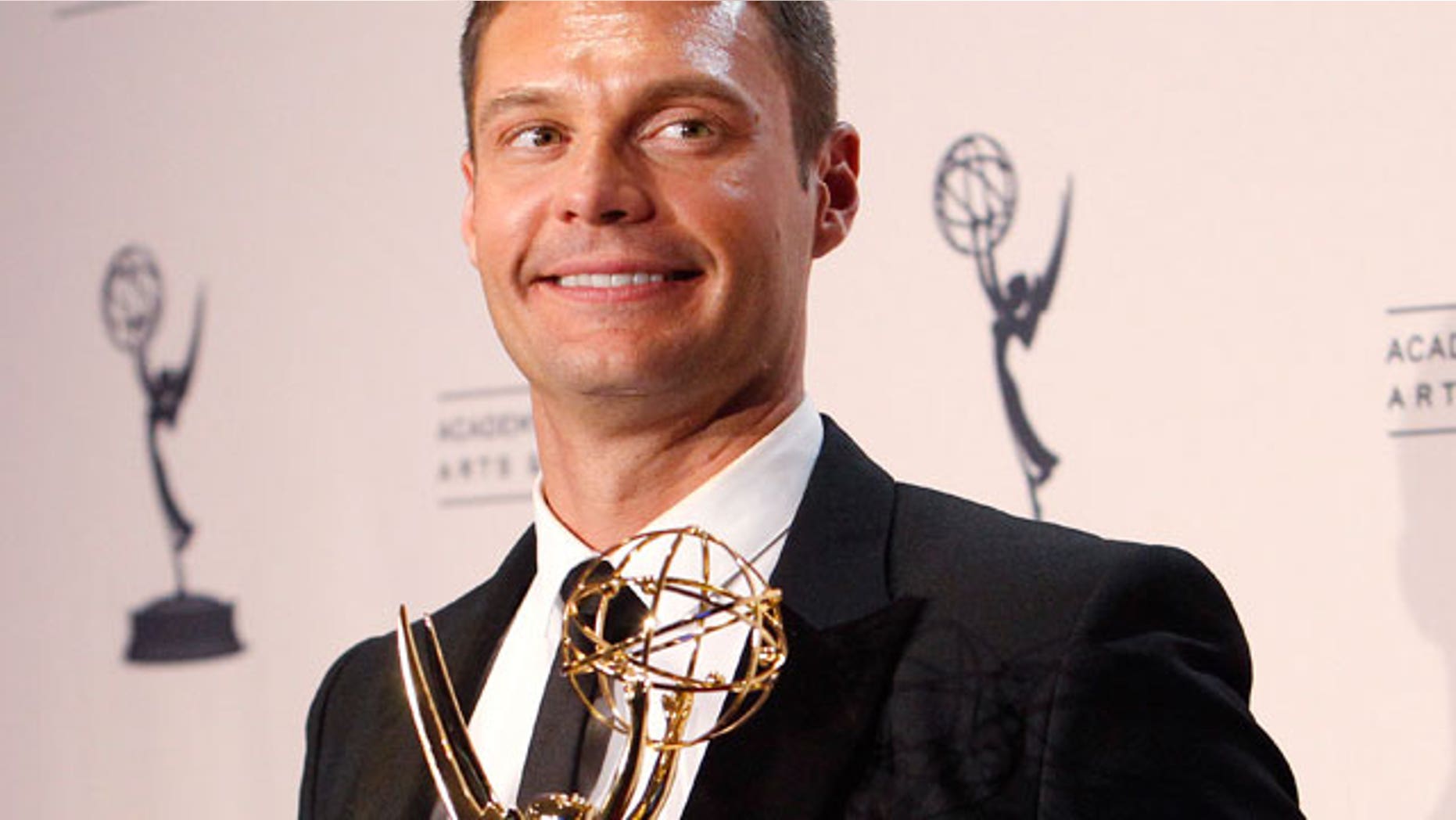 Aug. 2010: Seacrest holds his Emmy award for Outstanding Reality Program for "Jamie Oliver's Food Revolution" in Los Angeles. (Reuters)