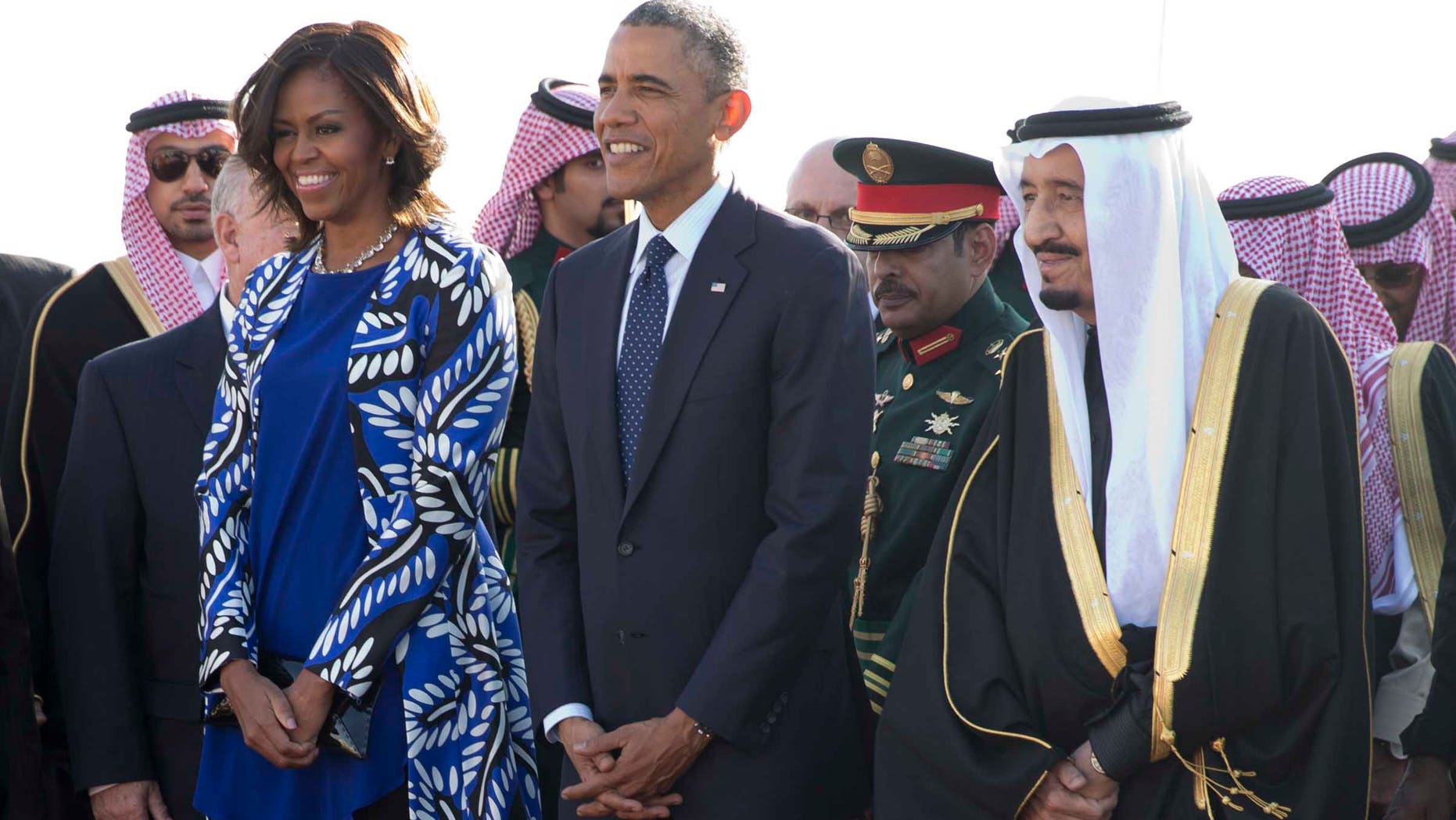 President Barack Obama and first lady Michelle Obama stand with new Saudi King Salman bin Abdul Aziz they arrive on Air Force One at King Khalid International Airport, in Riyadh, Saudi Arabia, Tuesday, Jan. 27, 2015. (AP Photo/Carolyn Kaster)