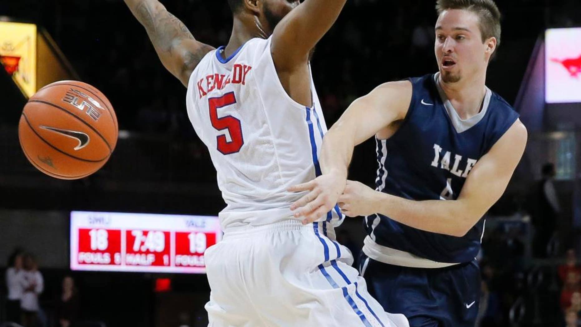 FILE - In this Nov. 22, 2015 FILE photo, Yale's Jack Montague, right, passes the ball around SMU's Markus Kennedy during an NCAA college basketball game in Dallas. Montague's attorney said he was expelled from Yale in Feb. 2016, because of a sexual assault allegation. Montague filed a federal lawsuit over the expulsion, alleging the school mishandled information that originated with someone other than the alleged victim. (AP Photo/Tony Gutierrez, File)