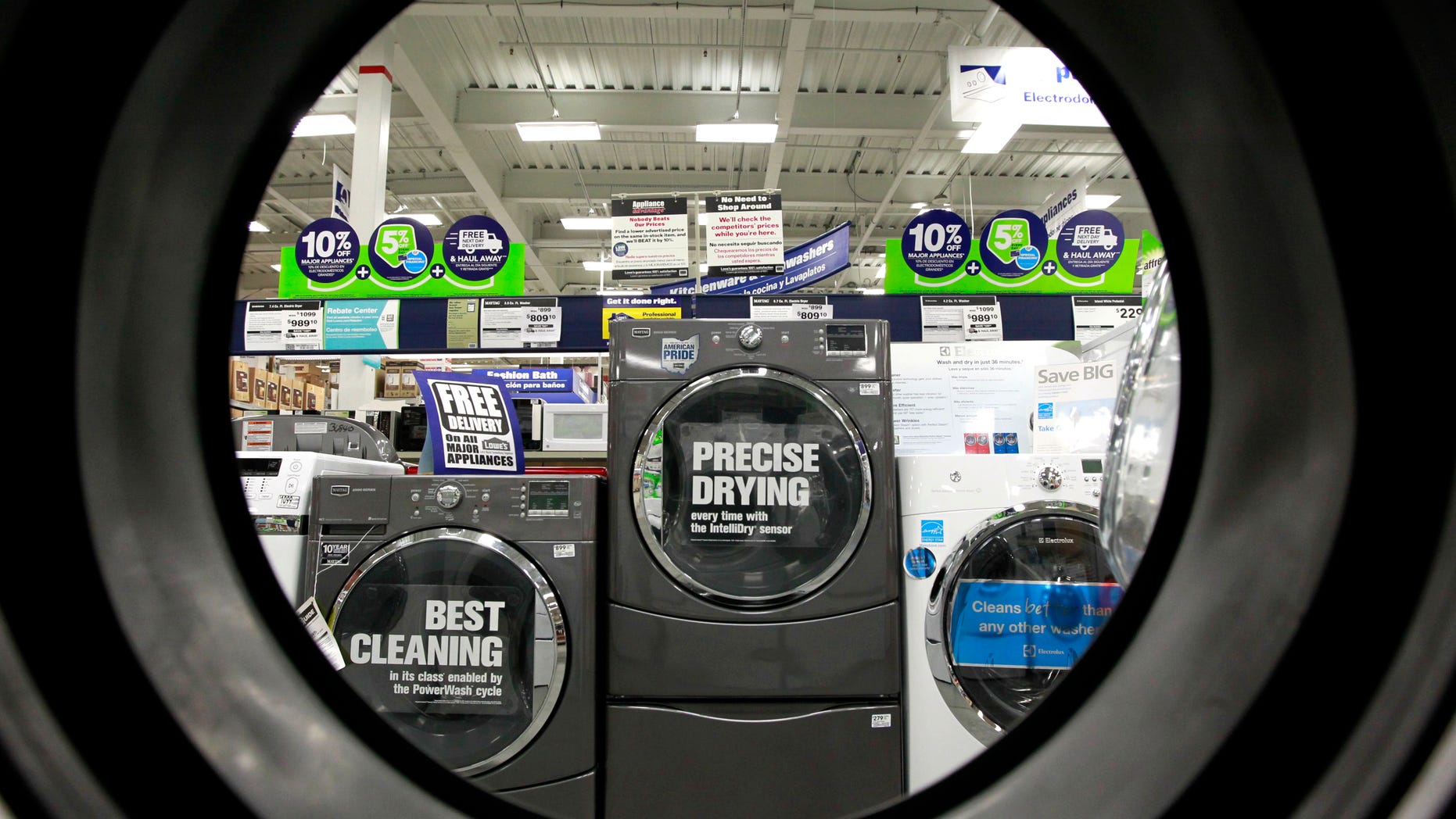 FILE - In this Monday, Sept. 10, 2012 file photo, dryers are seen from the inside of another clothes' dryer, foreground, at a Lowe's store location, in Framingham, Mass. Lowe's Cos. Inc. reports quarterly financial results before the market opens on Wednesday, May 22, 2013. (AP Photo/Steven Senne, File)