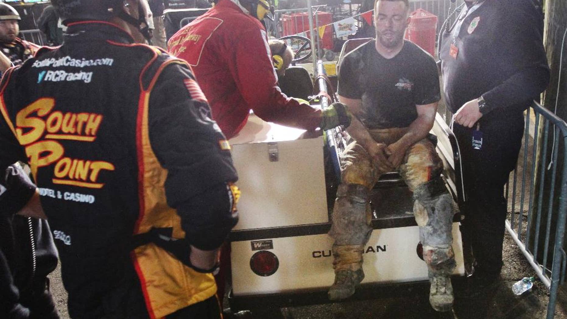 An injured crew member receives medical attention after a fire on pit road during the NASCAR Xfinity series auto race at Richmond International Raceway, in Richmond, Va., Friday April 24, 2015. (Skip Rowland/Richmond Times-Dispatch via AP)