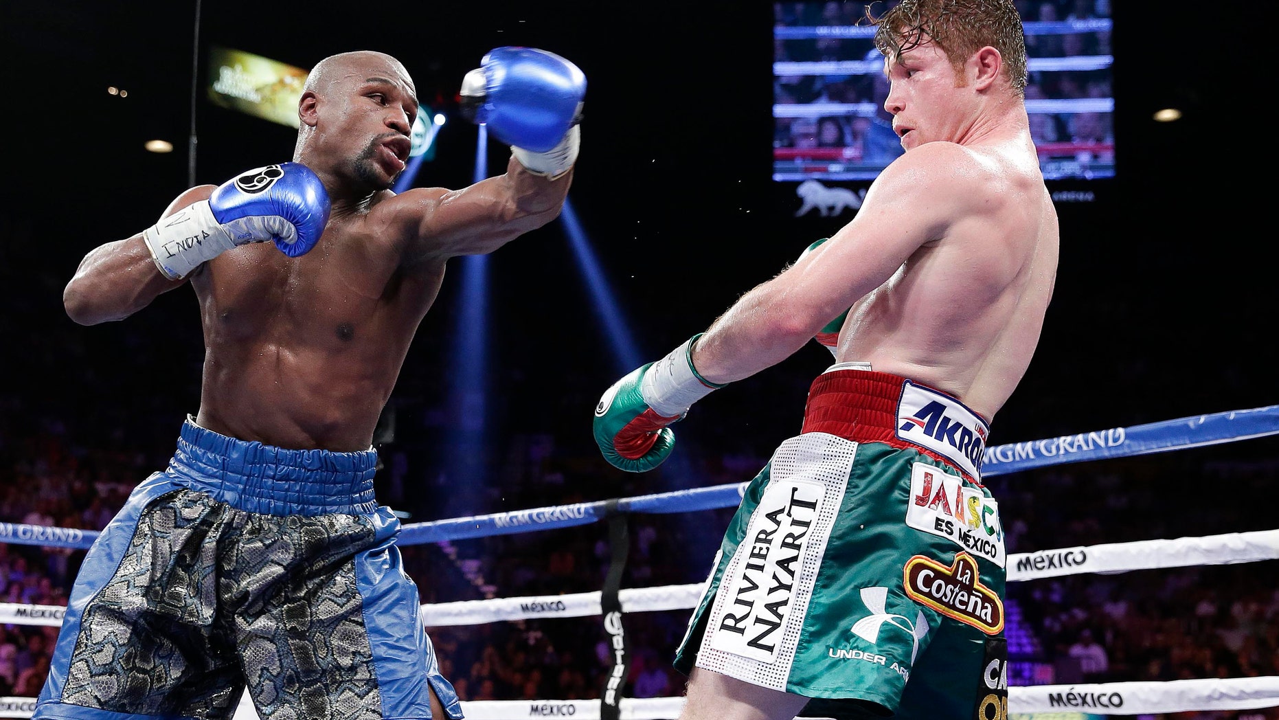 Floyd Mayweather Jr. throws a jab at Canelo Alvarez in the eighth round during a 152-pound title fight, Saturday, Sept. 14, 2013, in Las Vegas. (AP Photo/Eric Jamison)