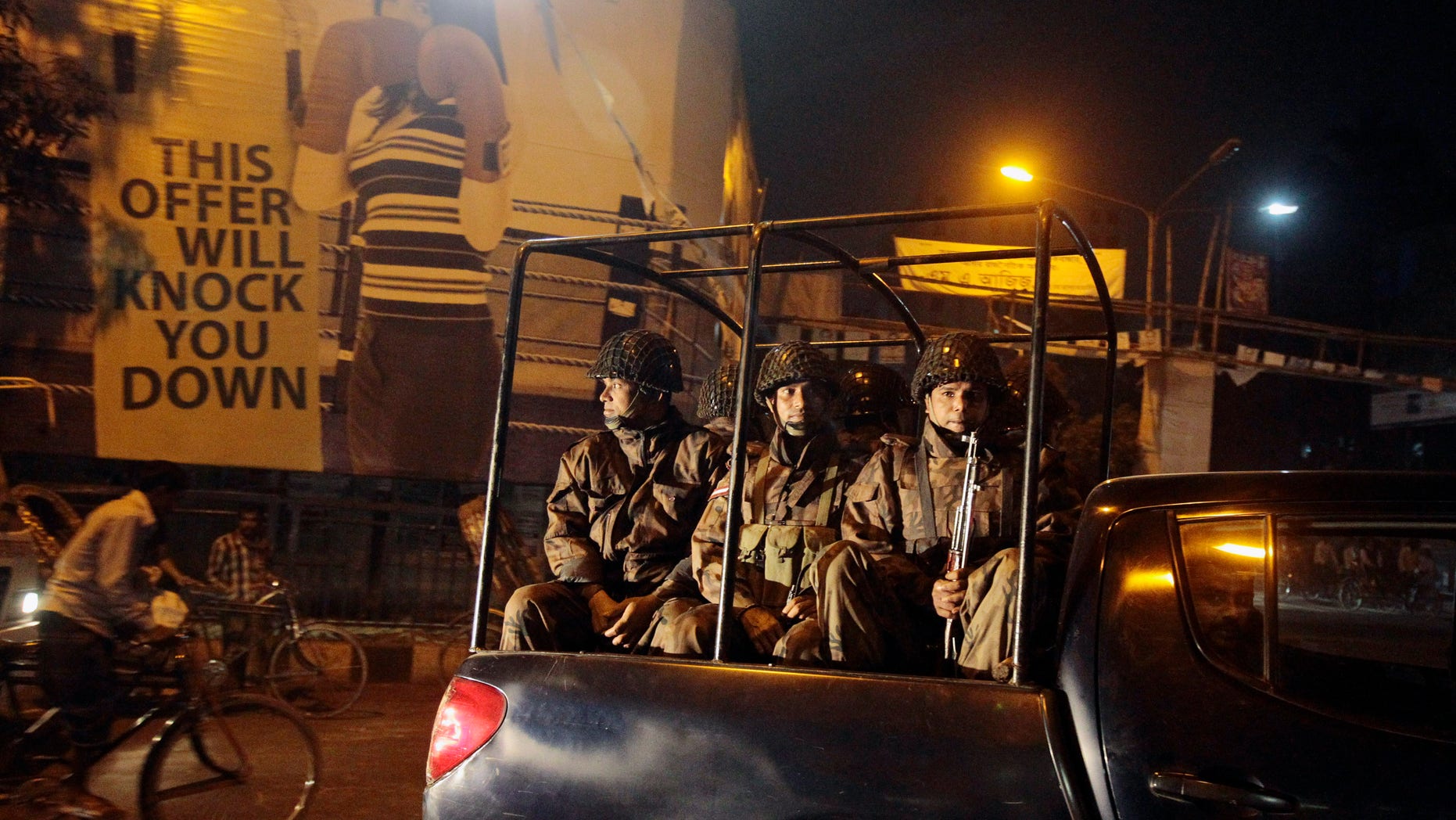 Security personnel from Border Guard Bangladesh (BGB) patrol around the city following the execution of Islamist opposition leader Abdul Quader Mollah convicted of war crimes committed during the country’s 1971 war of independence against Pakistan, in Dhaka, Bangladesh, Saturday, Dec. 14, 2013. The execution sparked violent protests Friday as activists torched homes and businesses belonging to government supporters in a fresh wave of bloodshed ahead of elections next month. (AP Photo/A.M. Ahad)
