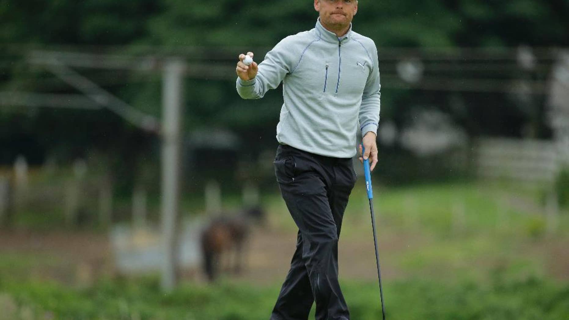 Soren Kjeldsen of Denmark acknowledges the spectators on the 10th green during the second round of the British Open Golf Championship at the Royal Troon Golf Club in Troon, Scotland, Friday, July 15, 2016. (AP Photo/Matt Dunham)