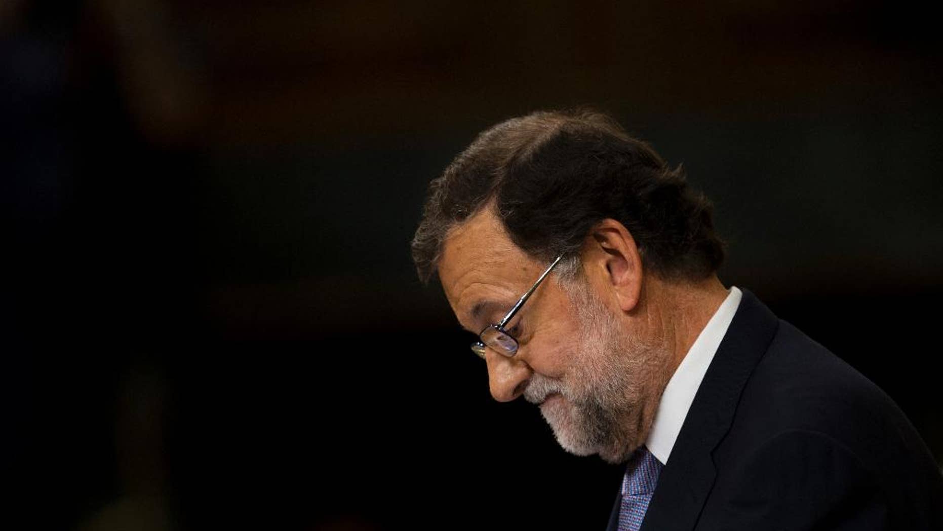 Spain's acting Prime Minister and Popular party leader Mariano Rajoy looks down as he addresses lawmakers during the second of the two day investiture debate, at the Spanish parliament in Madrid, Wednesday, Aug. 31, 2016. Rajoy lost the investiture voting on Wednesday but he has a second chance Friday when he only needs more votes in favor than against. (AP Photo/Francisco Seco)
