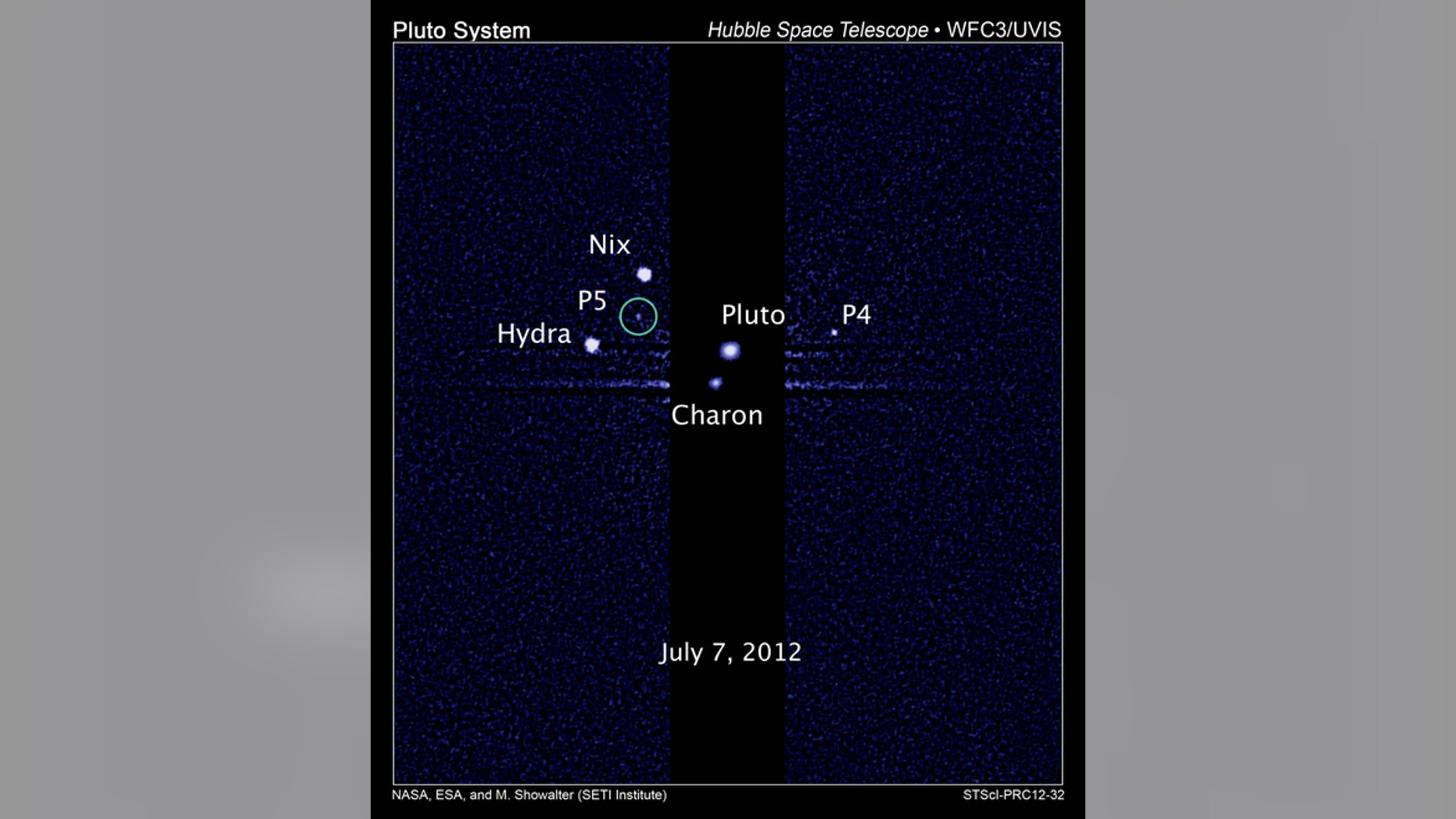 This image, taken by NASA's Hubble Space Telescope, shows five moons orbiting the distant, icy dwarf planet Pluto. The green circle marks the newly discovered moon, designated P5, as photographed by Hubble's Wide Field Camera 3 on July 7, 2012.