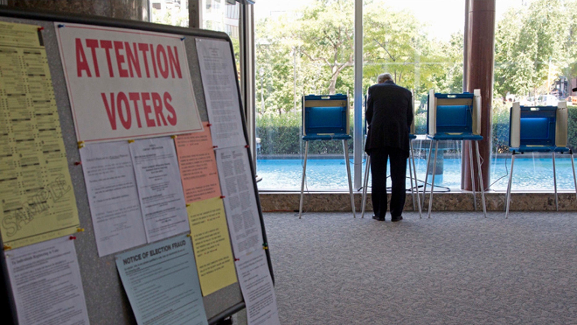 FILE - In this Sept. 9, 2010 file phoro, a lone voter takes part in early voting in Milwaukee. The Supreme Court deals with churning election rules in several states less than a month from November's voting, blocking voter ID laws in Wisconsin while siding with Republicans for stricter rules in North Carolina and Ohio. In Texas, a federal court strikes down a voter ID law, but the state may still appeal that ruling. (AP Photo/Morry Gash)