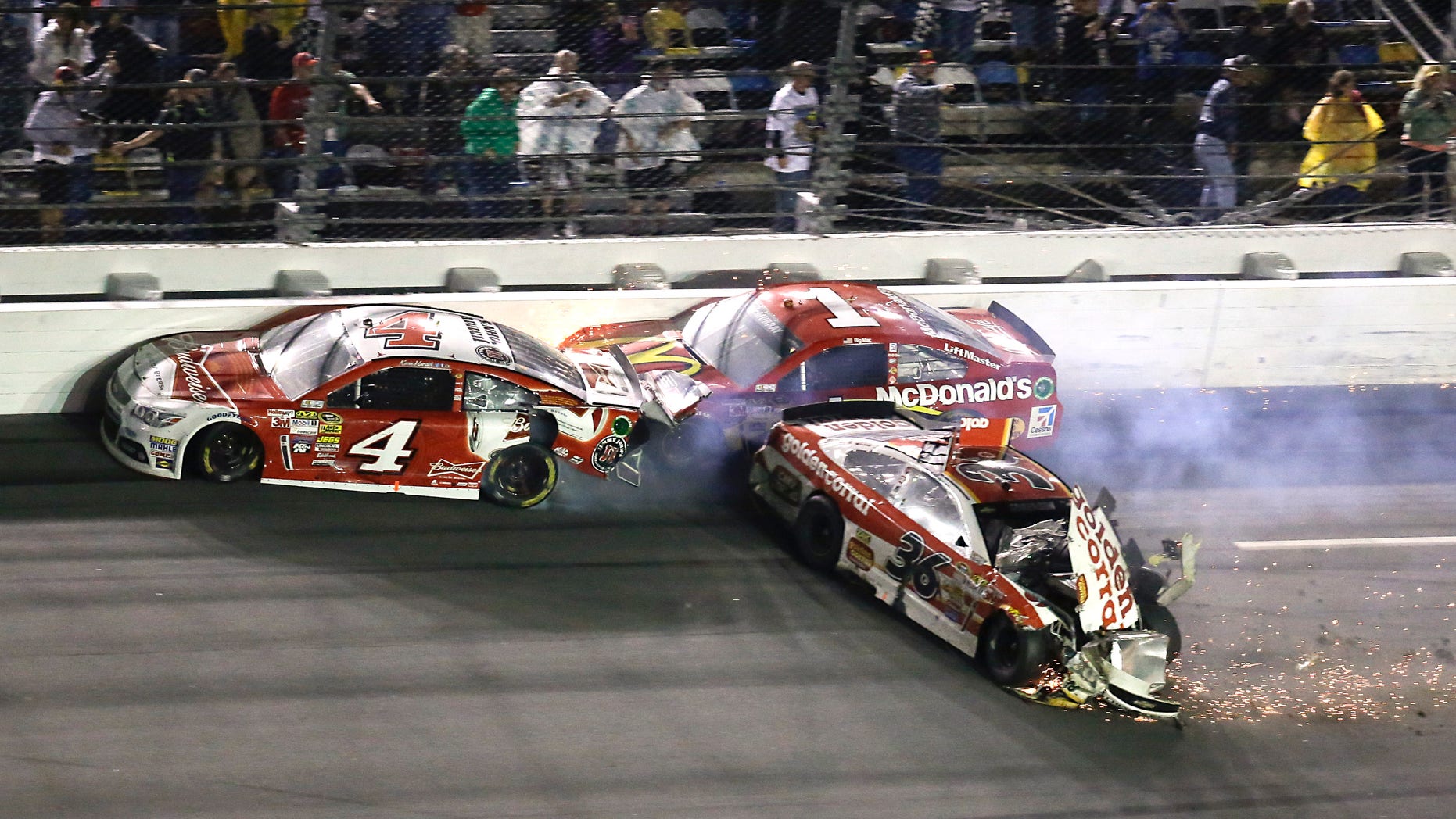 Kevin Harvick (4), Jamie McMurray (1) and Reed Sorenson (36) crash on the front stretch on the last lap of the Daytona 500 NASCAR Sprint Cup Series auto race at Daytona International Speedway in Daytona Beach, Fla., Sunday, Feb. 23, 2014. (AP Photo/John Raoux)