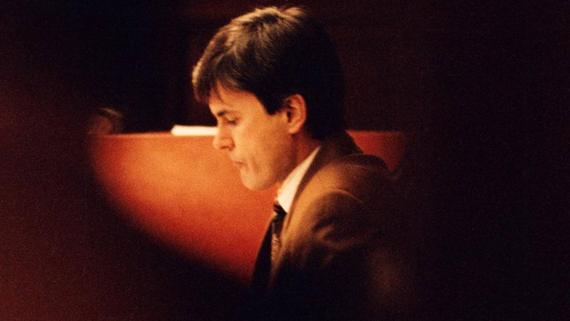 FILE - In this Feb. 2, 1995 file photo, John Ausonius sits during a trial in Stockholms district court. A Swedish court has said one of Sweden's most notorious prisoners must be extradited to Germany to stand trial in the murder of a Jewish woman in Frankfurt in 1992. The Sodertorns District Court said Thursday, Dec.15, 2016 John Ausonius should serve any German sentence he may get in Sweden. (Tobias Rostlund/TT News Agency via AP, File)