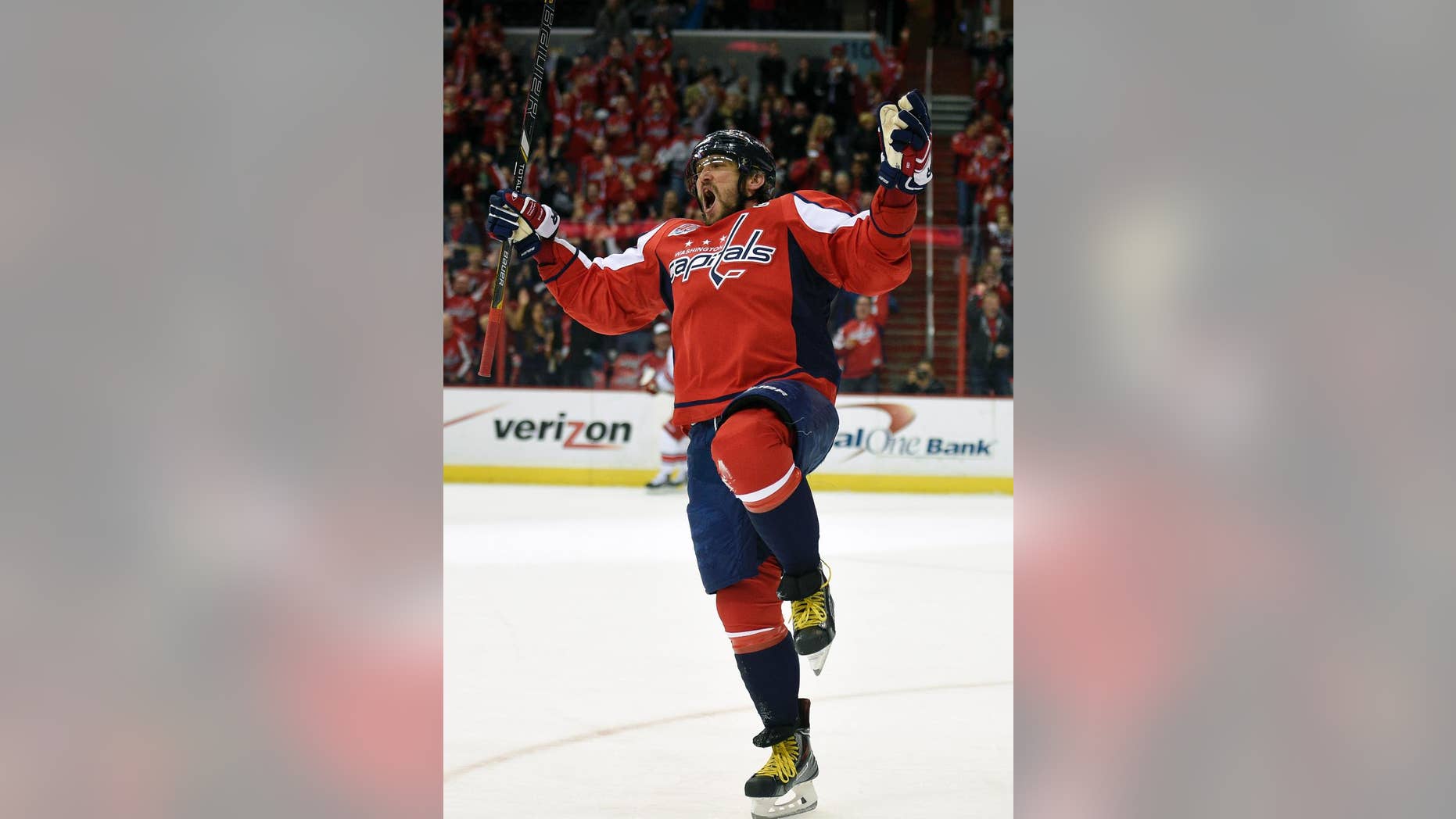 Washington Capitals left wing Alex Ovechkin (8), of Russia, celebrates his goal against the Carolina Hurricanes during the first period of an NHL hockey game, Tuesday, March 31, 2015, in Washington. It was Ovechkins' 50th goal of the year. (AP Photo/Nick Wass)