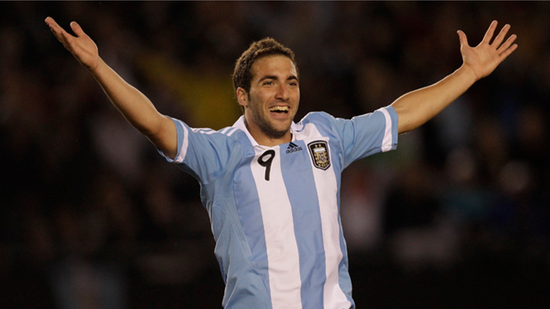 Argentina's Gonzalo Higuain celebrates after scoring his team's third goal during a World Cup 2014 qualifying soccer game against Chile in Buenos Aires, Argentina, Friday, Oct. 7, 2011. (AP Photo/Eduardo Di Baia)