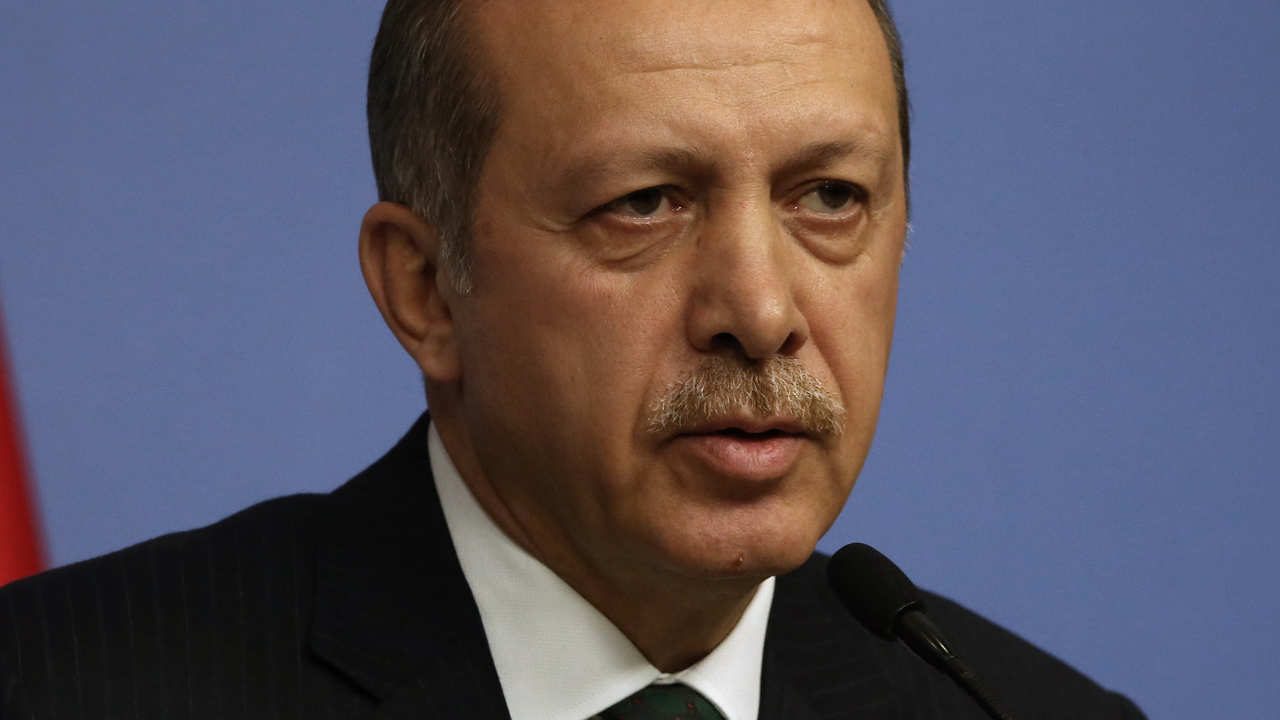 Turkey's Prime Minister Recep Tayyip Erdogan speaks during a news conference in Ankara, Turkey, Wednesday, Dec. 18, 2013. Istanbul police leading a major corruption and bribery investigation targeting allies of Erdogan have seized shoe boxes stashed with money totaling some $4.5 million in the home of the chief executive of a state-owned bank, a Turkish news agency reported Wednesday. The Dogan news agency said the shoe boxes were discovered on bookshelves in the home of Halk Bank's CEO, Suleyman Aslan, who is among dozens of people — including the sons of government ministers — detained for questioning as part of the corruption and bribery investigation.(AP Photo/Burhan Ozbilici)