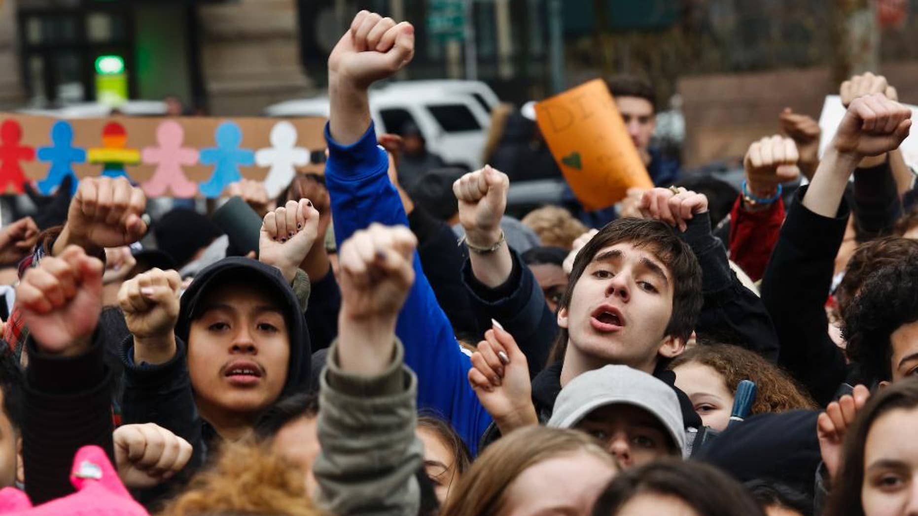 Students from high schools and colleges throughout New York city protest with clenched fists, during a rally against President Donald Trump's executive order banning travel from seven Muslim-majority nations, Tuesday Feb. 7, 2017, in New York's Foley Square. (AP Photo/Bebeto Matthews)