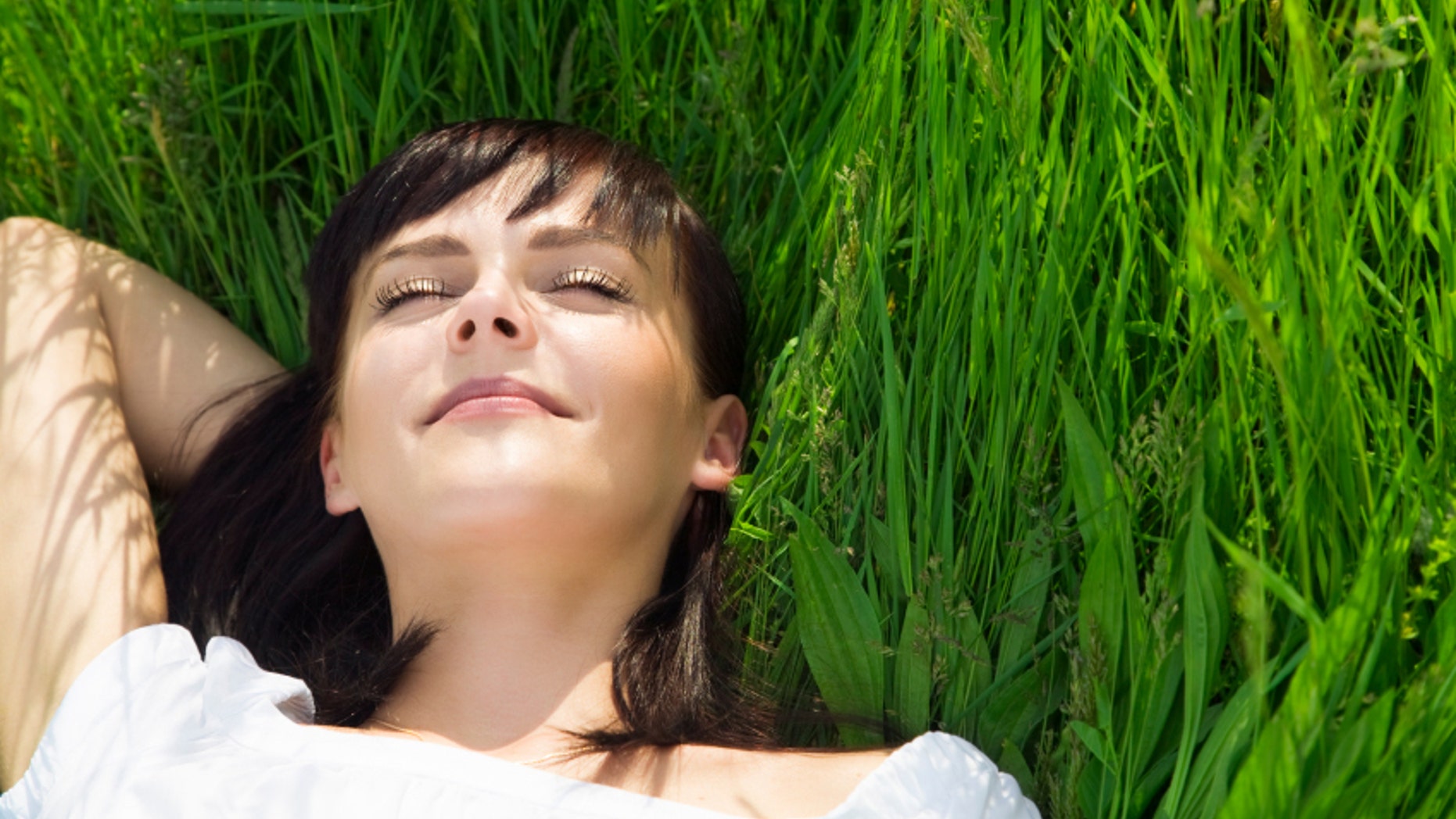 beautiful girl lying down of grass. Copy space
