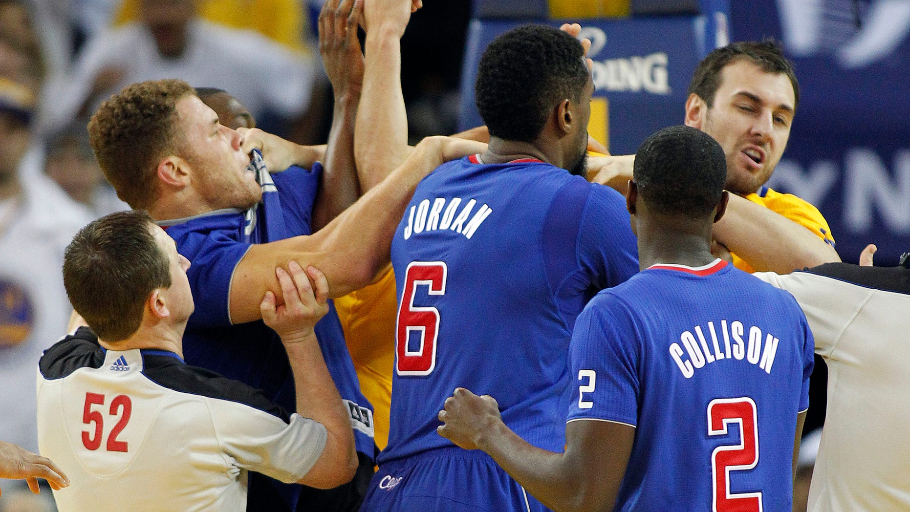 FILE - In this Dec. 25, 2013, file photo, Los Angeles Clippers power forward Blake Griffin, left, fights with Golden State Warriors center Andrew Bogut, right, as Clippers center DeAndre Jordan (6) and Darren Collison (2) look on during the second half of an NBA basketball game in Oakland, Calif. Griffin was ejected from the game. Whether the Warriors and Clippers are growing into unlikely California rivals might still be up for debate. This much is clear: neither team likes the other. The Pacific Division-leading Clippers visit the Warriors on Thursday night for the first time since Golden State's win on Christmas was marred by multiple technical fouls, elbows and heated verbal exchanges. (AP Photo/Tony Avelar, File)