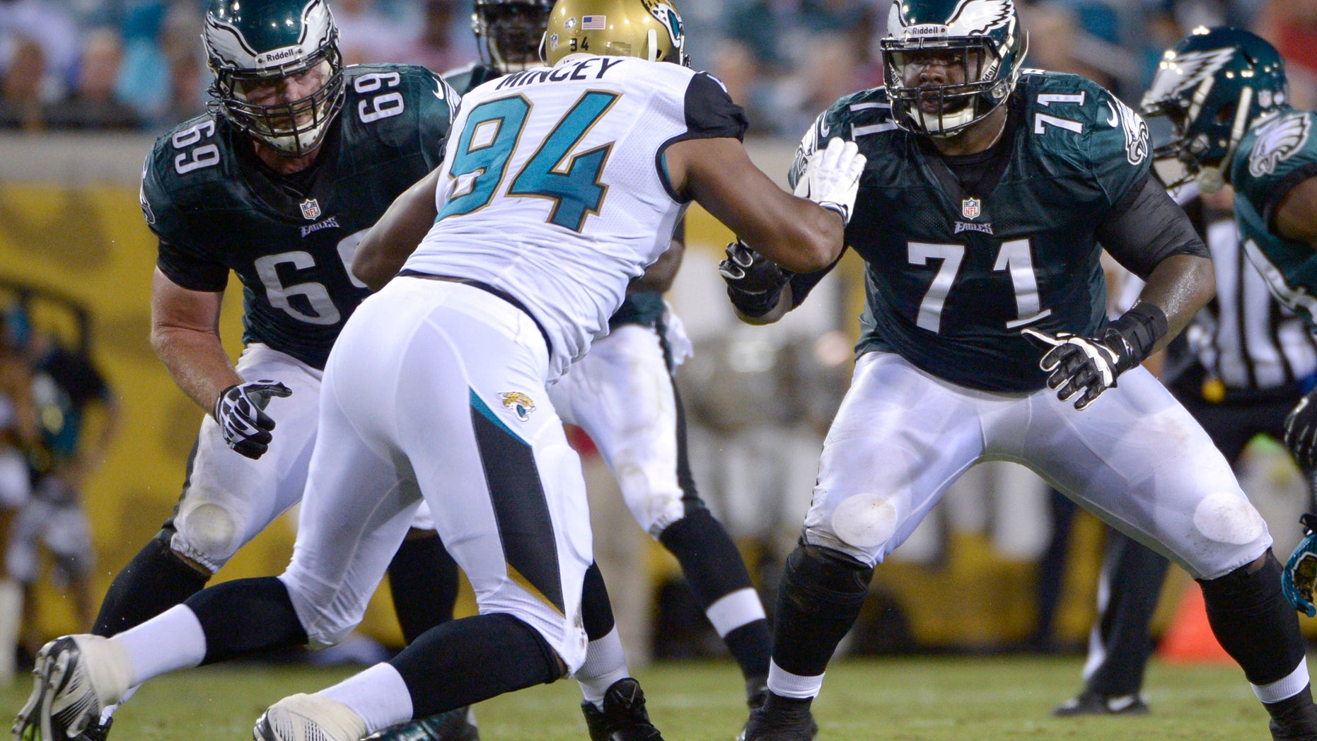 ADVANCE FOR WEEKEND EDITIONS OF DEC. 14-15 - FILE - In an Aug. 24, 2013, file photo Philadelphia Eagles guard Evan Mathis (69) and tackle Jason Peters (71) block against Jacksonville Jaguars defensive end Jeremy Mincey (94) during the first half of an NFL preseason football game in Jacksonville, Fla. Jason Peters, Evan Mathis, Jason Kelce, Todd Herremans and Lane Johnson don't get much recognition, but coaches and teammates credit the big guys upfront for helping the offense lead the NFL in rushing. (AP Photo/Phelan M. Ebenhack, File)