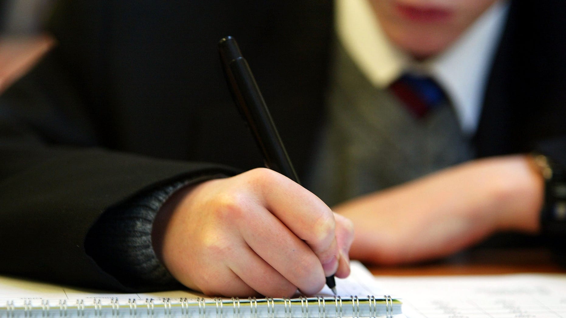 LONDON - SEPTEMBER 4: A student writes during a lesson at The Cardinal Vaughan Memorial School on September 4, 2003 in London. Students across the United Kingdom are returning to school for the start of the 2003/4 academic year. (Photo by Scott Barbour/Getty Images)