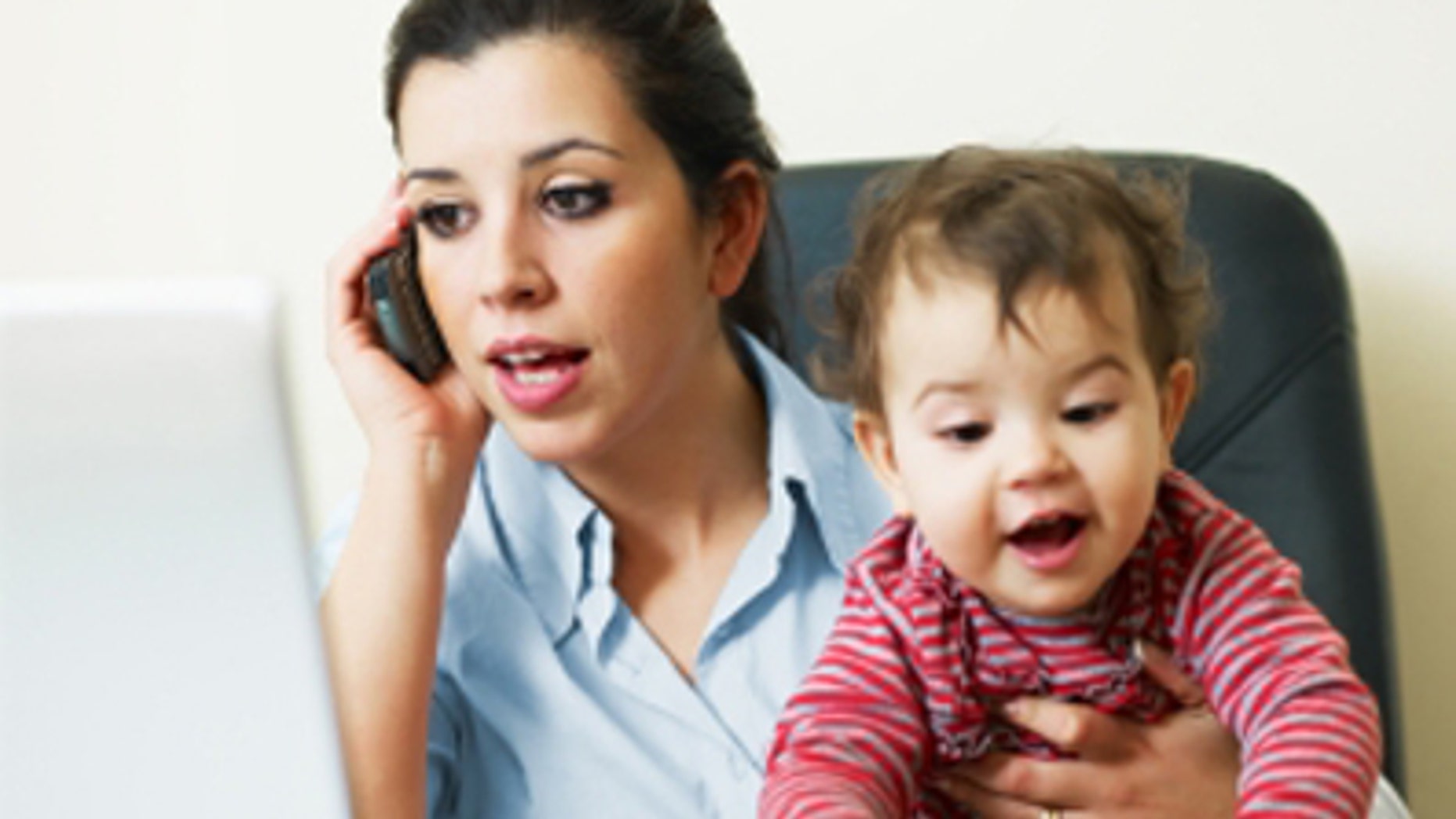 stressed business woman in office, holding her little girl while talking on mobile phone. Vertical shape, Copy space
