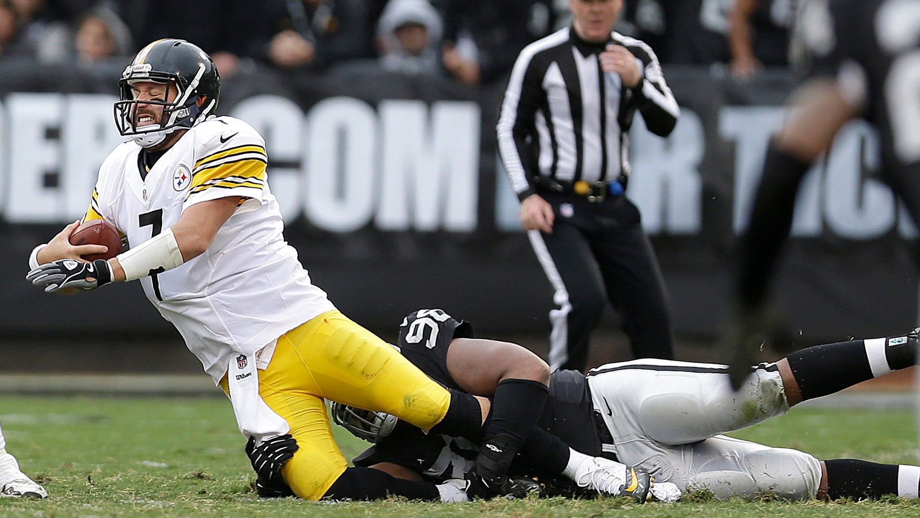 Pittsburgh Steelers quarterback Ben Roethlisberger (7) is sacked by Oakland Raiders defensive tackle Vance Walker during the fourth quarter of an NFL football game in Oakland, Calif., Sunday, Oct. 27, 2013. (AP Photo/Marcio Jose Sanchez)