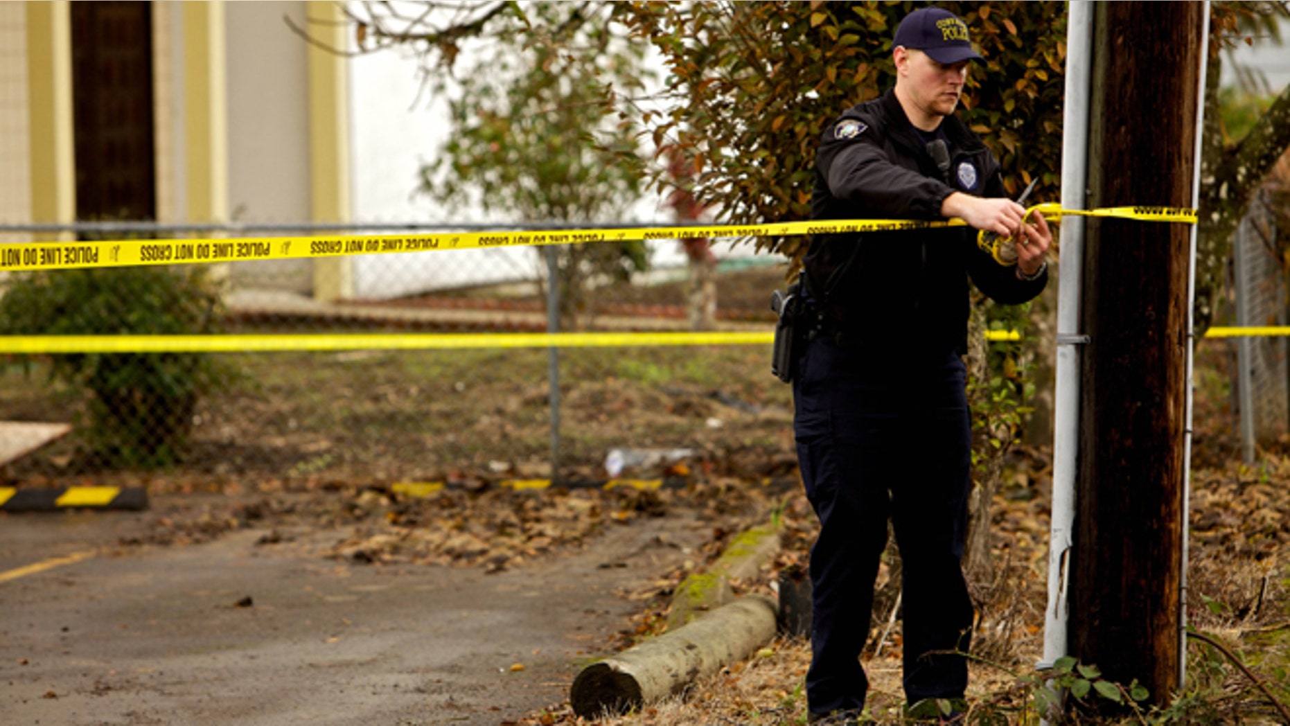 CORVALLIS, OR - NOVEMBER 28: A Corvallis police officer puts up police tape in front of the Salman Al Farisi Islamic Center on November 28, 2010 in Corvallis, Oregon. An arsonist set fire to the prayer center, which was sometimes attended by suspected Portland car bomber Mohamed Osman Mohamud. Mohamud, a Somali-born teenager, was arrested and charged with attempted use of a weapon of mass destruction when he allegedly attempted to set off a car bomb during Christmas tree lighting ceremony in Pioneer Courthouse Square in Portland, Oregon. It was reported that civilians were not at risk because the bomb was supplied to him by undercover federal agents and the explosives were inert. (Photo by Craig Mitchelldyer/Getty Images)