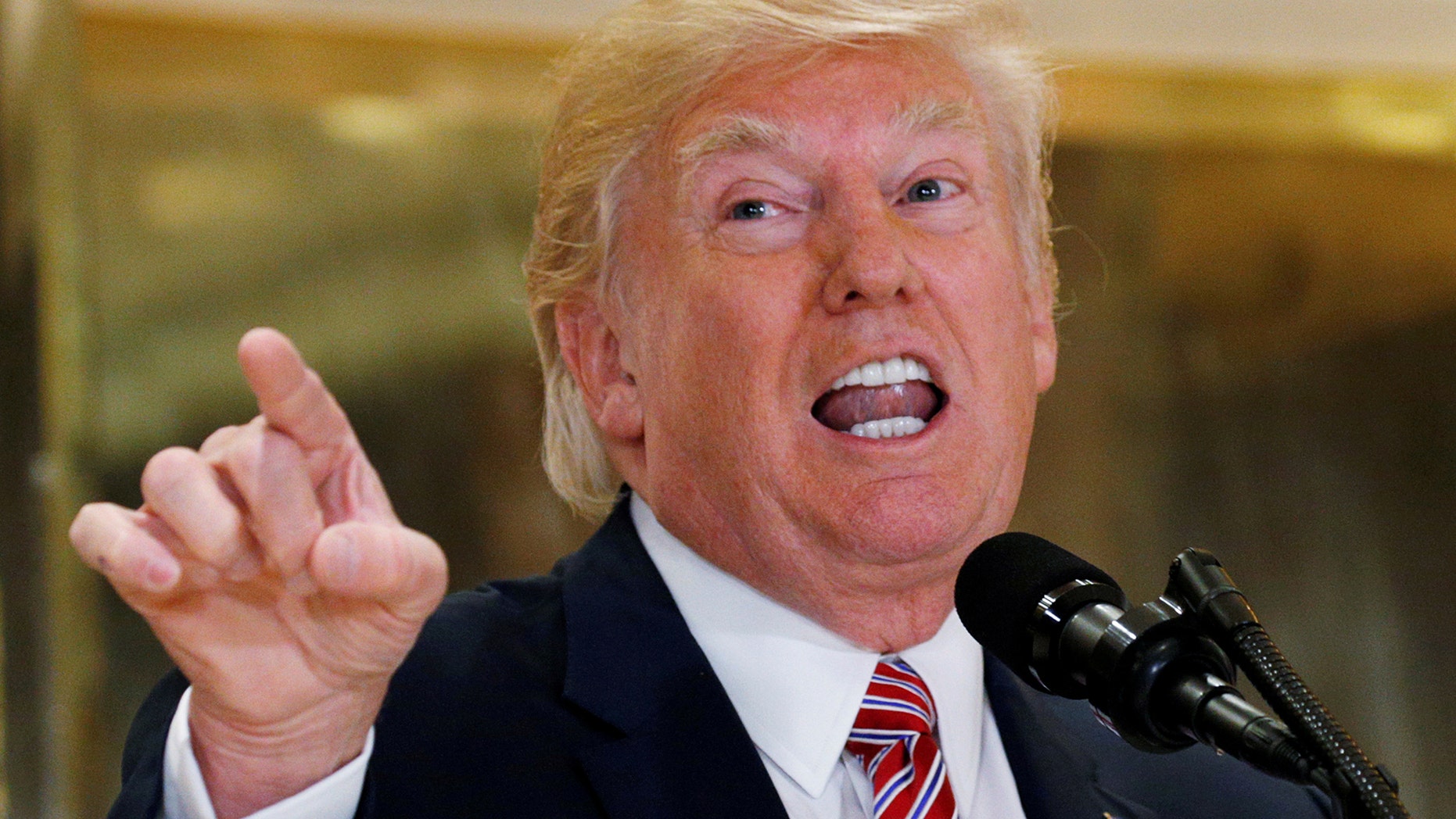 U.S. President Donald Trump answers questions about his response to the violence, injuries and deaths at the "Unite the Right" rally in Charlottesville as he talks to the media in the lobby of Trump Tower in Manhattan, New York, U.S., August 15, 2017. REUTERS/Kevin Lamarque TPX IMAGES OF THE DAY - RTS1BXVI