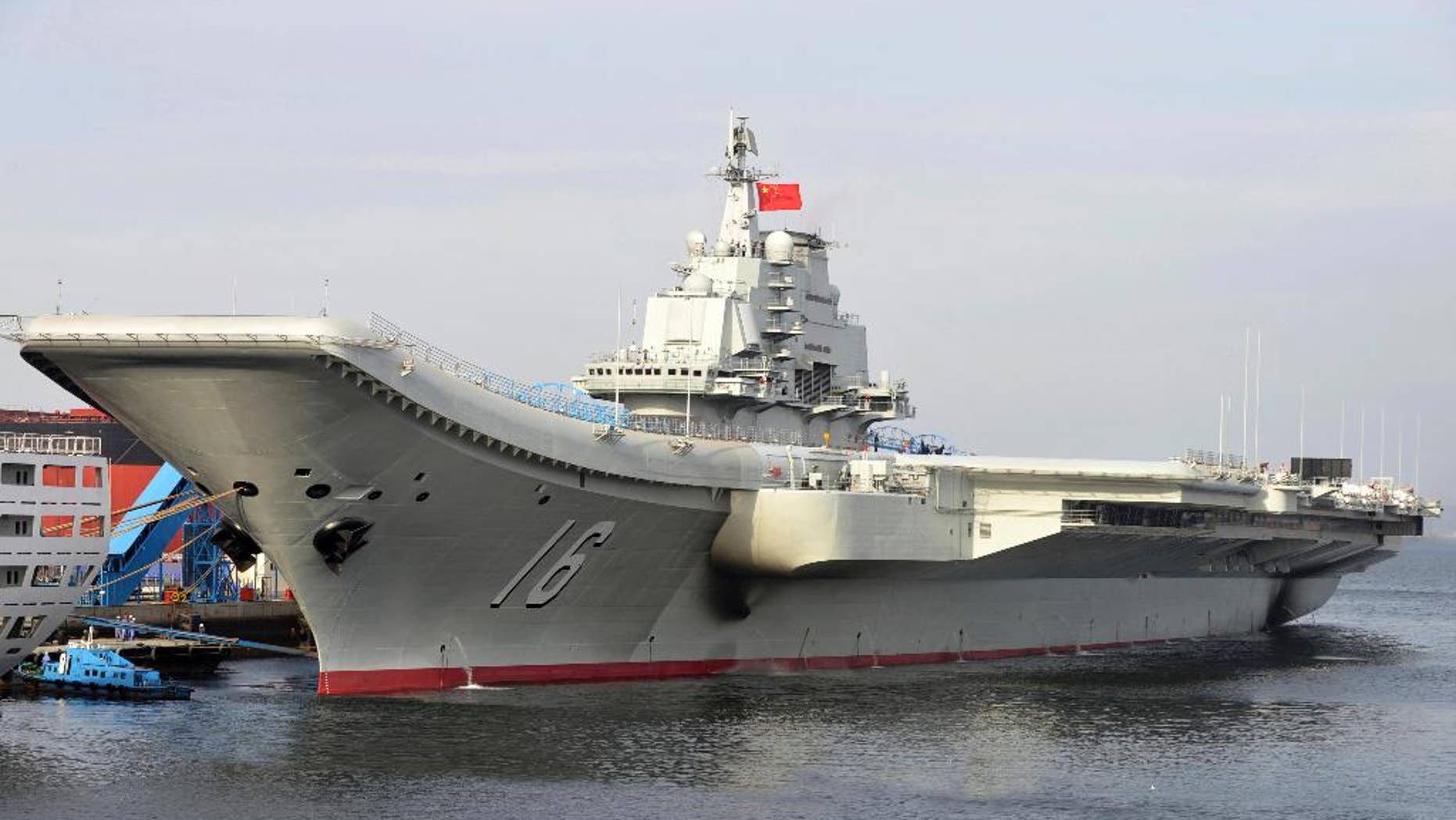 FILE - In this undated file photo released by China's Xinhua News Agency, China's aircraft carrier Liaoning berths in a port of China. China's military says its first aircraft carrier group has carried out a series of fighter launch, recovery and air combat exercises in the Yellow Sea amid tensions with the U.S. and Taiwan. The Defense Ministry announced late Friday that the Liaoning carrier group conducted the drills in the Yellow Sea in recent days and is scheduled to continue exercises farther afield. (AP Photo/Xinhua, Li Tang, File)