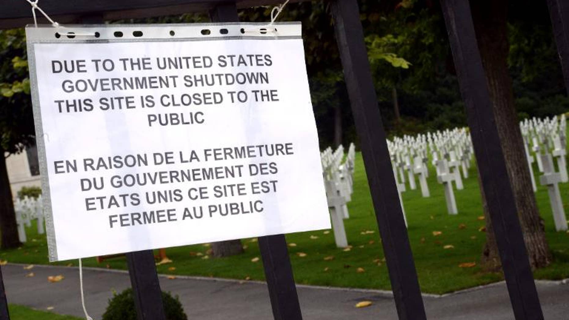 A board informs visitors of the closing of the Suresnes American Cemetery and Memorial, west of Paris, on October 1, 2013, after US Congress was unable to agree on a federal budget and shut down for the first time in 17 years