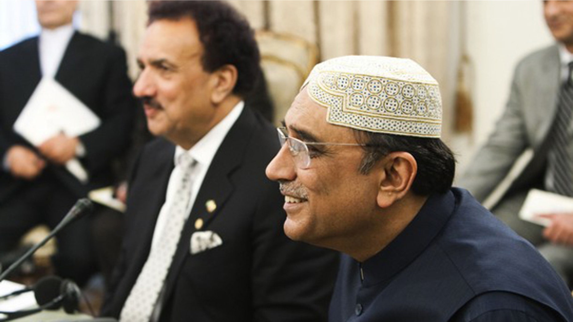 FILE: Pakistani President Asif Ali Zardari, right, and Pakistani Interior Minister Rahman Malik attend a trilateral meeting with their Iranian and Afghan counterparts in Tehran June 24.