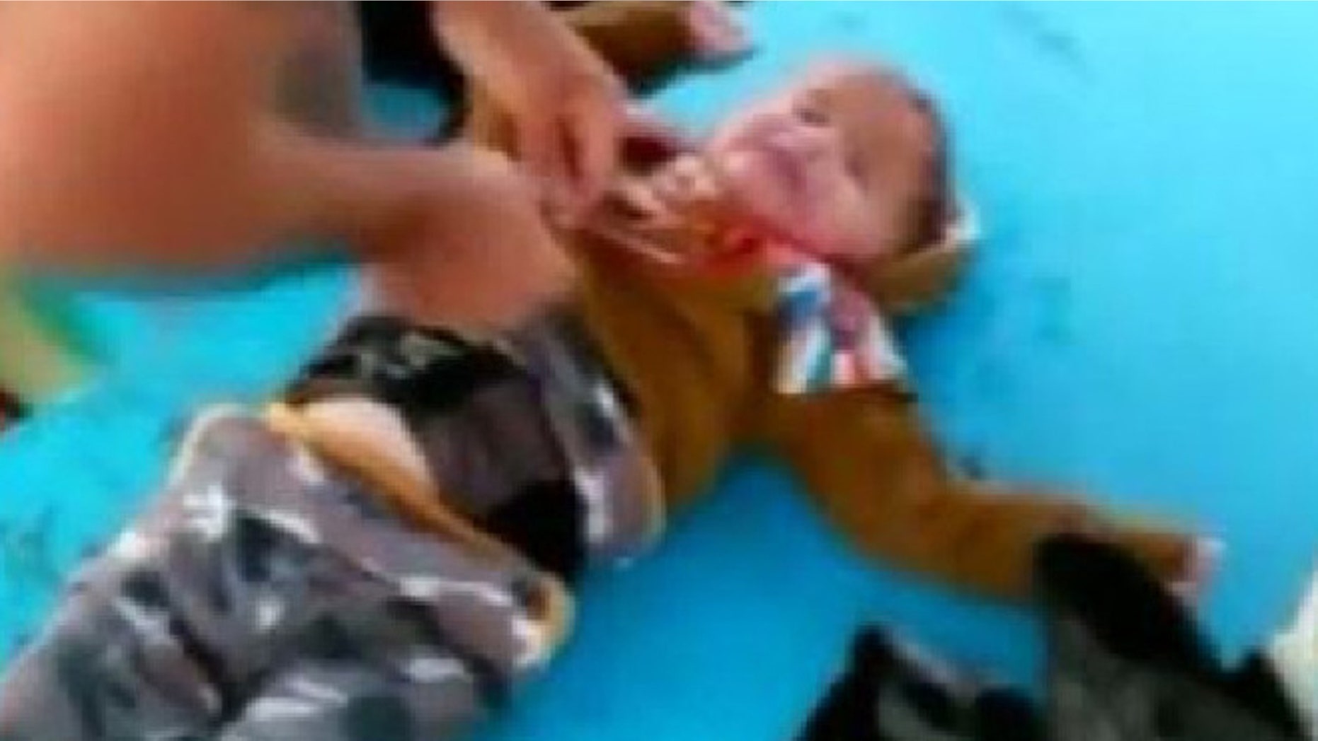Fishermen pull refugee baby from the Aegean Sea.