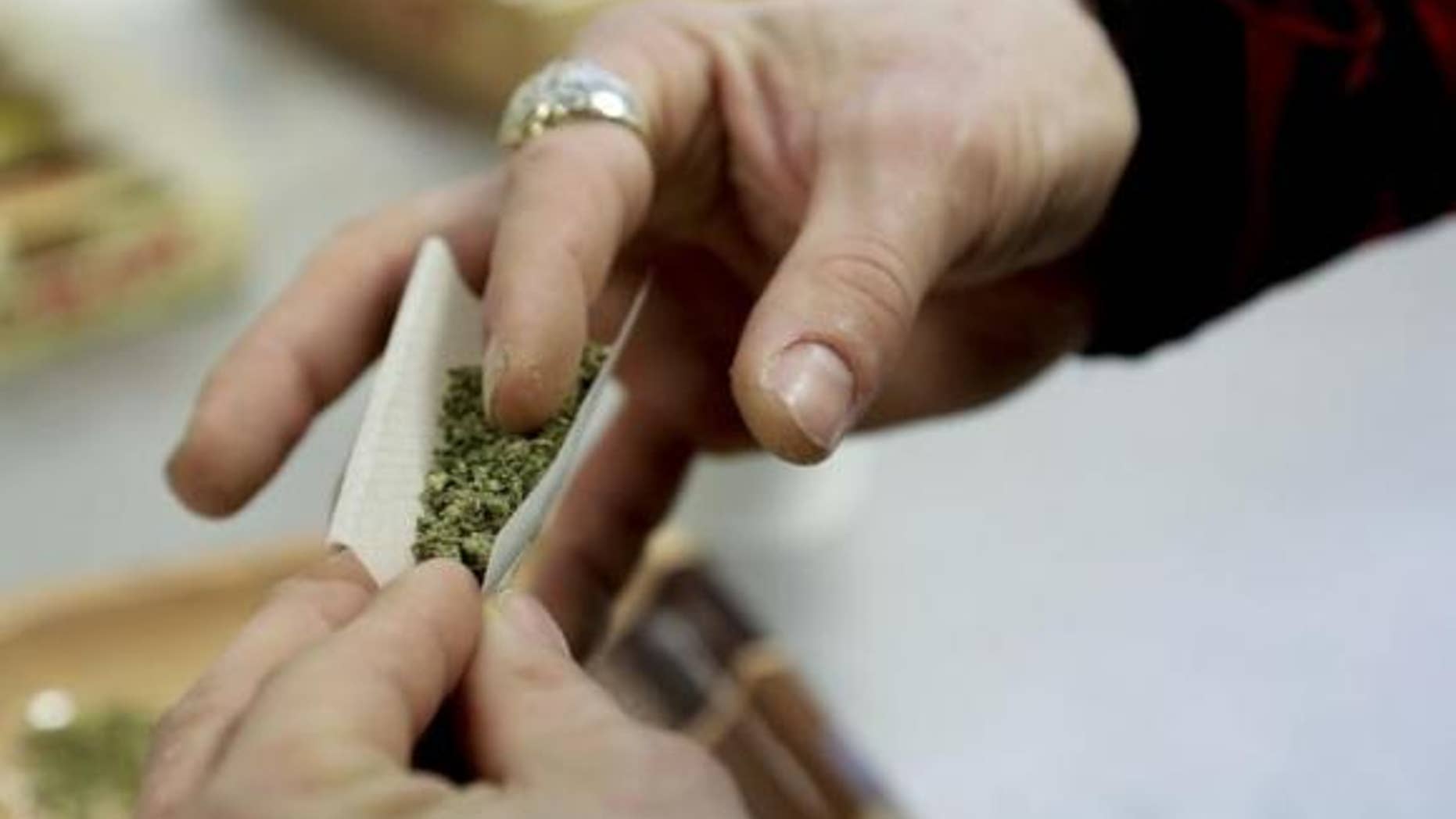 A participant practices rolling a joint at the Cannabis Carnivalus 4/20 event in Seattle, Washington April 20, 2014. REUTERS/Jason Redmond