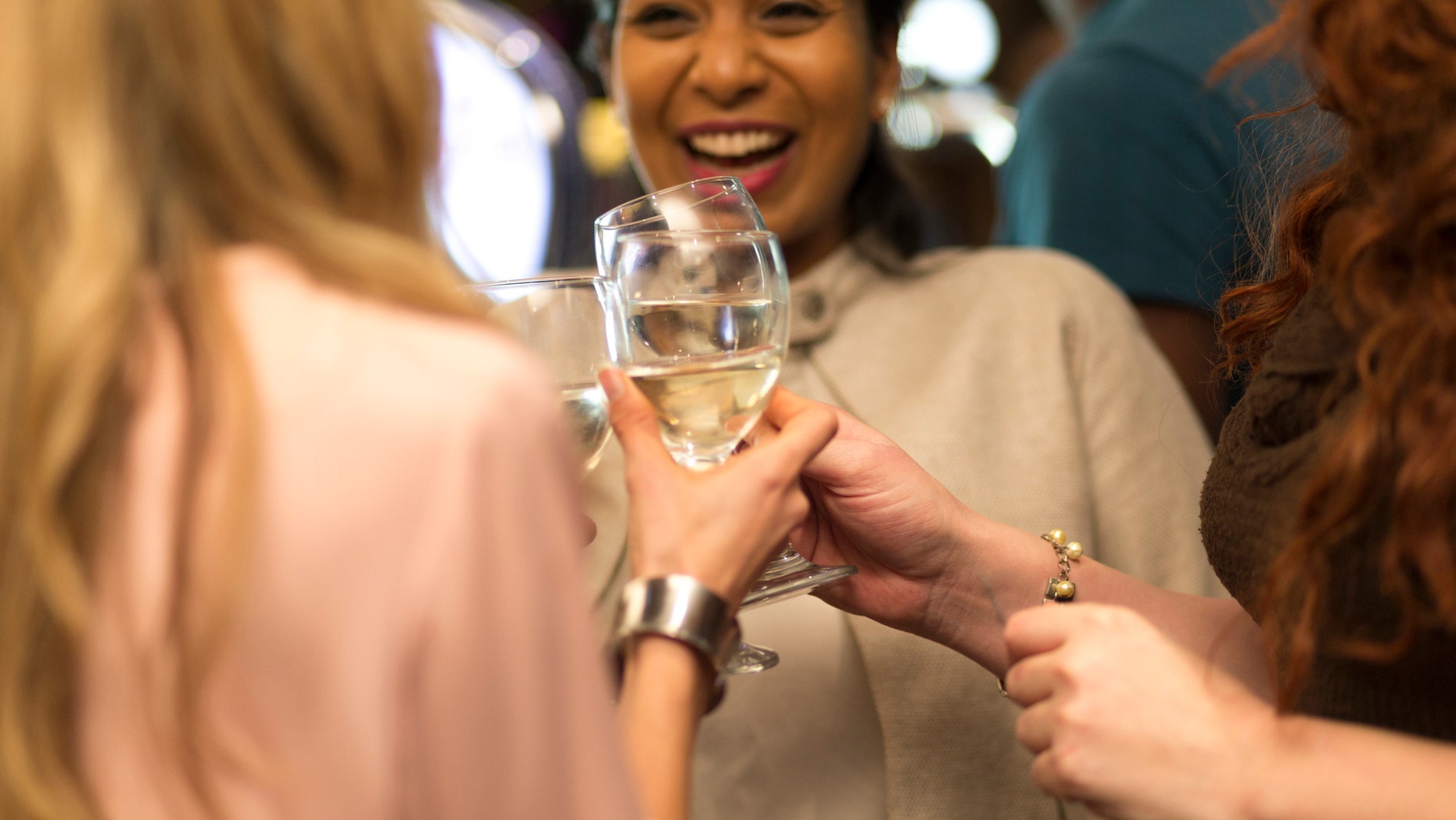 Three women toasting their glasses in a barThree women toasting their glasses in a bar