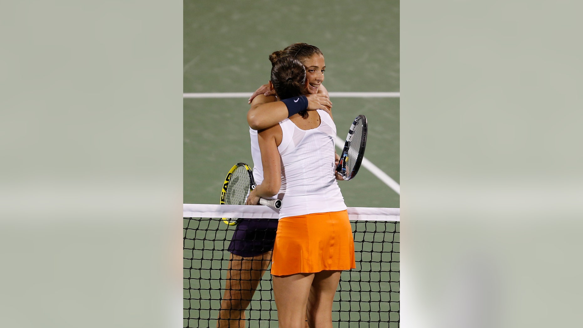 Sara Errani of Italy is congratulated by Roberta Vinci of Italy after winning the semifinals of the Dubai Duty Free Tennis Championships in Dubai, United Arab Emirates, Friday, Feb. 22, 2013. (AP Photo/Regi Varghese)