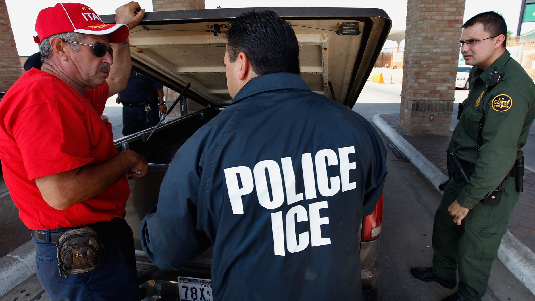 HIDALGO, TX - MAY 28: Special agents from Immigration and Customs Enforcement (ICE), Border Patrol, and Customs and Border Protection (CBP) question a man while his vehicle is searched after he was stopped heading into Mexico at the Hidalgo border crossing on May 28, 2010 in Hidalgo, Texas. The inspection was part of a Department of Homeland Security (DHS) joint effort between ICE, CBP and Customs and Border Patrol. The organizations are trying to slow the flow of guns, money and drugs from the United State into Mexico. (Photo by Scott Olson/Getty Images)