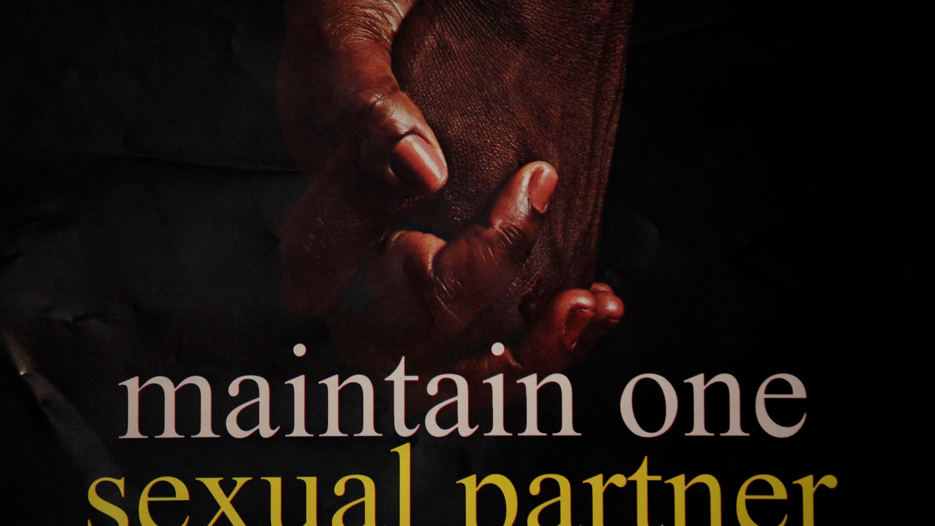 A poster with two hands held together with inscription ''Maintain one sexual partner'' is seen in an office in Lagos, Nigeria, Tuesday, Jan. 14, 2014. Police, working off a list of 168 suspects purportedly obtained through torture, are arresting dozens of gay men in Nigeria's northern Bauchi state, human rights activists said Tuesday. A new law in Nigeria, dubbed the "Jail the Gays" bill, is encouraging the persecution of gays and will endanger programs fighting HIV-AIDS in the gay community, said Dorothy Aken'Ova, executive director of Nigeria's International Center for Reproductive Health and Sexual Rights. On Monday, President Goodluck Jonathan's office confirmed that the Nigerian leader signed the Same Sex Marriage Prohibition Act that criminalizes gay marriage, gay organizations and anyone working with or promoting them. (AP Photo/Sunday Alamba)