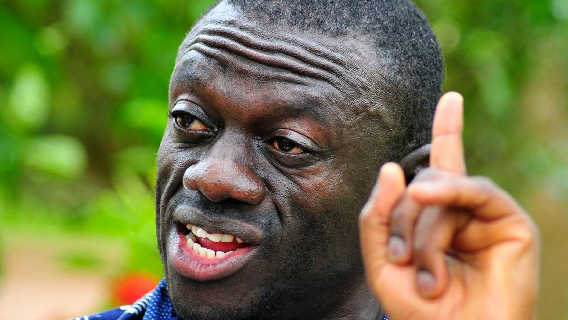 FILE - In this Wednesday, April 20, 2011 file photo, opposition leader Kiiza Besigye speaks during a rally in Kampala, Uganda. An opposition leader in Uganda who is running for president is under house arrest to prevent him from holding rallies that have been called illegal by the government, a police spokeswoman said. Kiiza Besigye of the Forum for Democratic Change party is being detained in his own home near the capital, Kampala, as a preventive measure “to ensure that there is no breach of peace,” said police spokeswoman Polly Namaye on Thursday, Oct. 15, 2015. (AP Photo/Ronald Kabuubi,File)