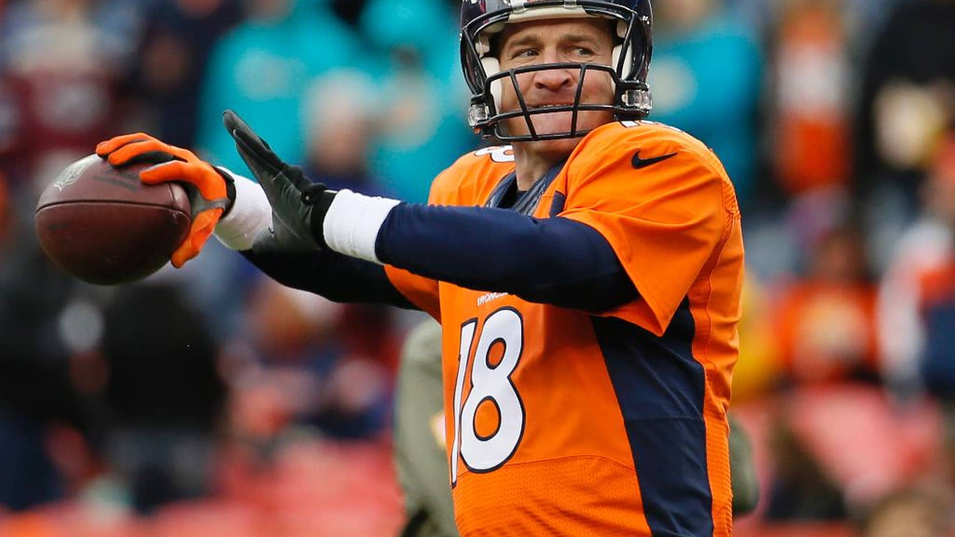 Denver Broncos quarterback Peyton Manning (18) warms up prior to an NFL football game against the Miami Dolphins, Sunday, Nov. 23, 2014, in Denver. (AP Photo/Jack Dempsey)