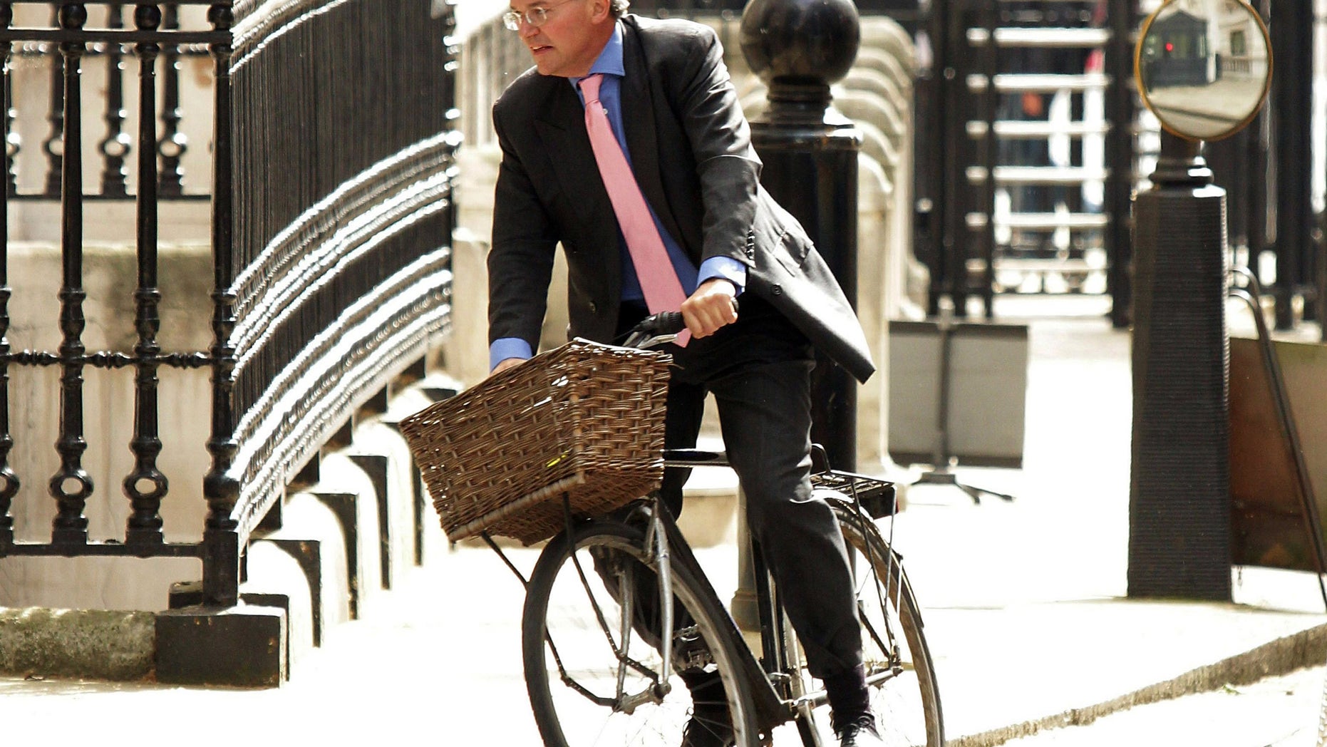 FILE - In this May 17, 2011 file photo, Andrew Mitchell arrives at Downing Street, London. Mitchell, who resigned from a government post over allegations that he used derogatory remarks against police officers called on Tuesday, Dec. 18, 2012 for a full inquiry into the dispute amid new claims that police fabricated the evidence. Mitchell quit as the government's chief whip in September after he was accused of swearing at police officers who stopped him from wheeling his bicycle through the Downing Street gates. (AP Photo/PA, Yui Mok, File) UNITED KINGDOM OUT, NO SALES, NO ARCHIVE