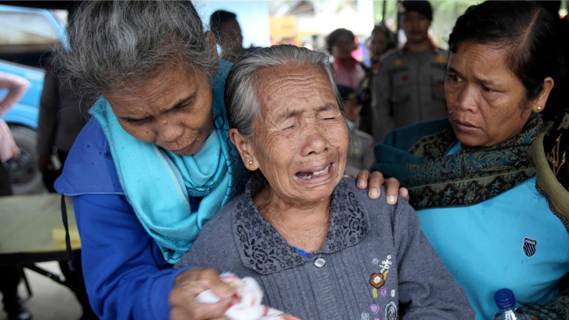 Relatives of victims of a sunken ferry weep as they wait for news at Tigaras port in Lake Toba, North Sumatra, Indonesia.