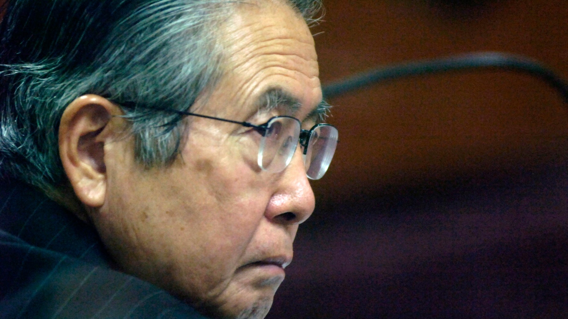 FILE - In this Jan. 23, 2008 file photo, Peru's former President Alberto Fujimori attends a session of his trial at a police base in Lima, Peru. Incarcerated for authorizing death squads and corruption, the former leader is not permitted to give interviews or make public statements. Yet he has 10,000 Twitter followers three weeks after opening an account, and he’s used YouTube three times to make short audio statements, setting off a media sensation in Peru as he rallies supporters and trades barbs with political foes. (AP Photo/Karel Navarro, File)