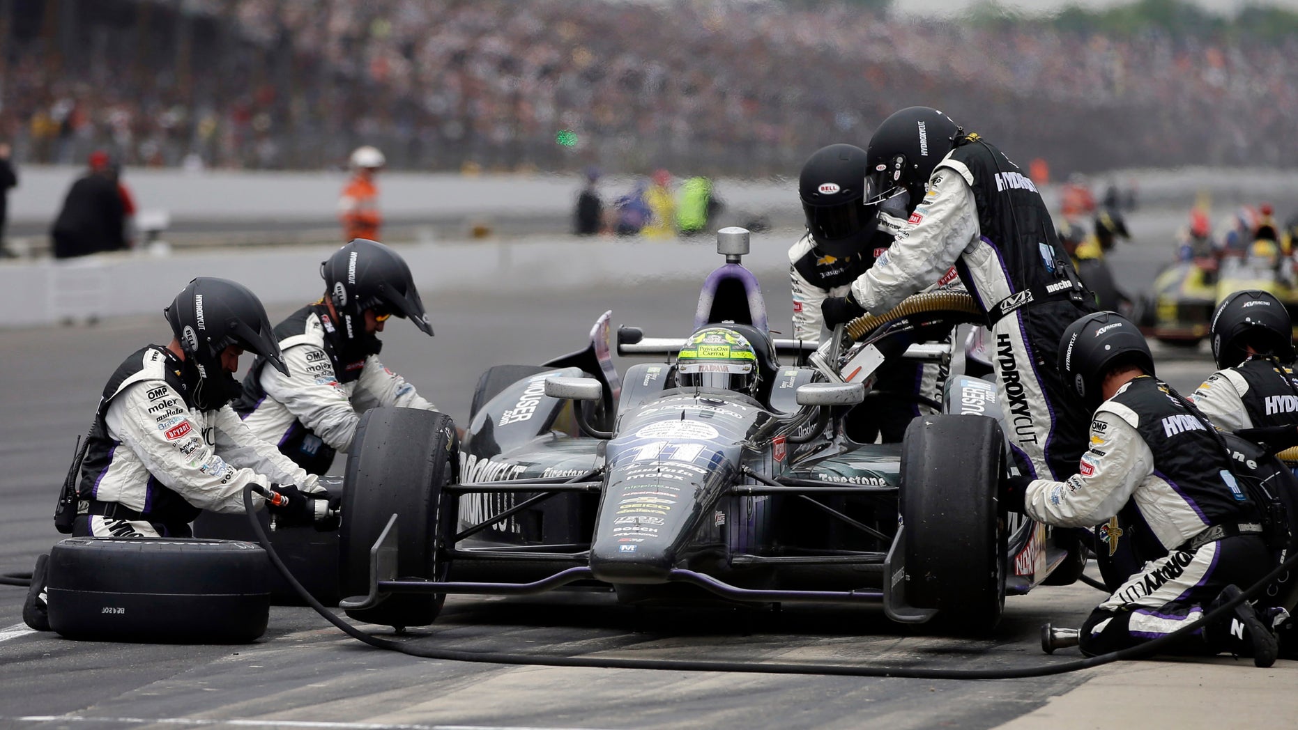 Tony Kanaan, of Brazil, makes a pit stop during the Indianapolis 500 auto race at the Indianapolis Motor Speedway in Indianapolis Sunday, May 26, 2013. (AP Photo/Darron Cummings)