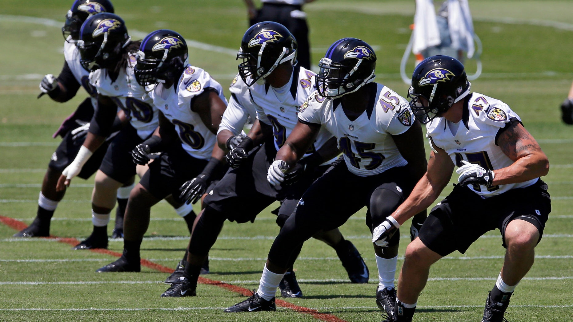 A group of Baltimore Ravens linebackers run a drill during NFL football practice at the team's training facility in Owings Mills, Md., Friday, May 31, 2013. (AP Photo/Patrick Semansky)