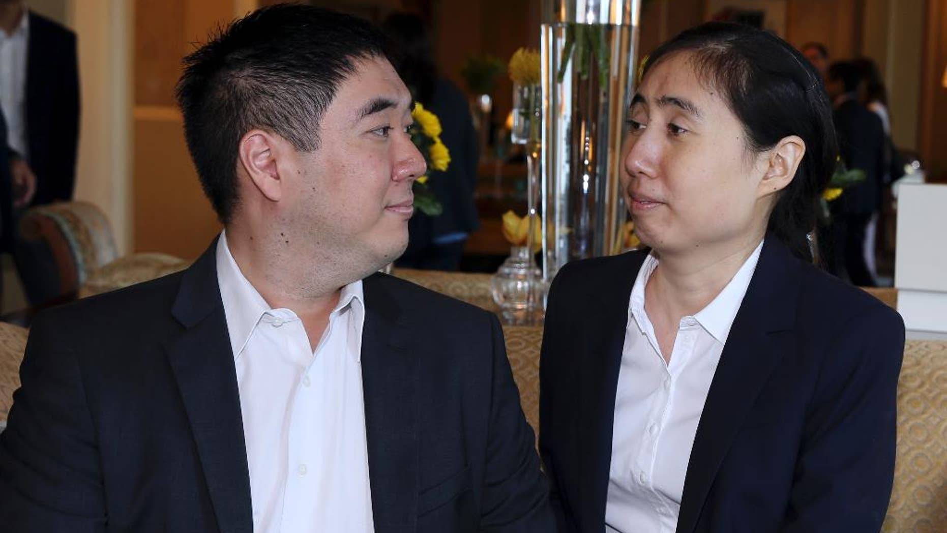 October 19, 2014: American couple Grace and Matthew Huang, sentenced to jail over charges they starved their 8-year-old adopted daughter to death, talk before they meet with U.S. Ambassador to Qatar, Dana Shell Smith, at a hotel in Doha. (AP Photo/Osama Faisal)