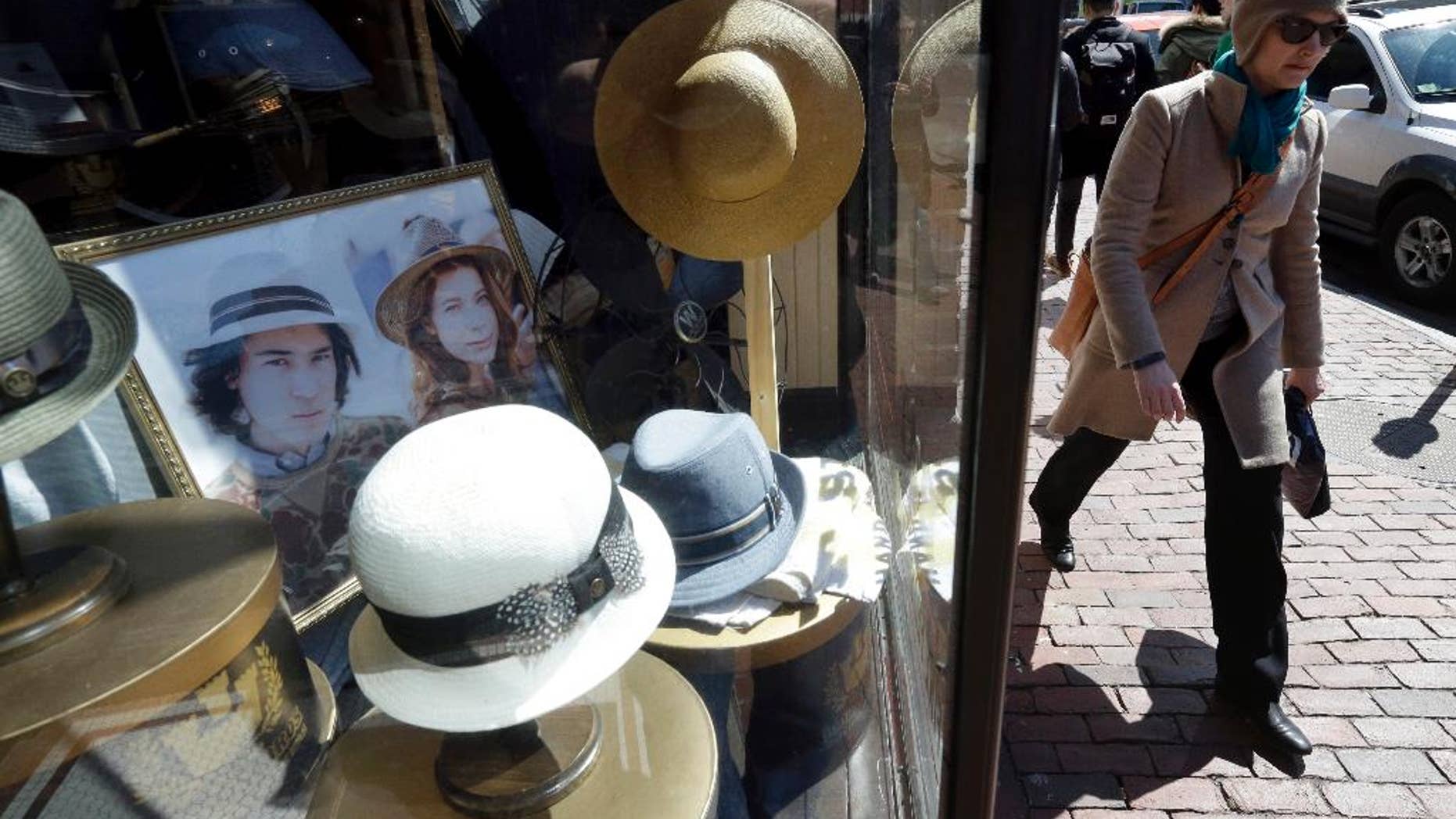 FILE - In this April 1, 2015 file photo, a pedestrian passes the entrance of a hat store in the Harvard Square neighborhood of Cambridge, Mass. The Commerce Department releases its March report on consumer spending, which accounts for 70 percent of economic activity, on Thursday, April 30, 2015. (AP Photo/Steven Senne, File)