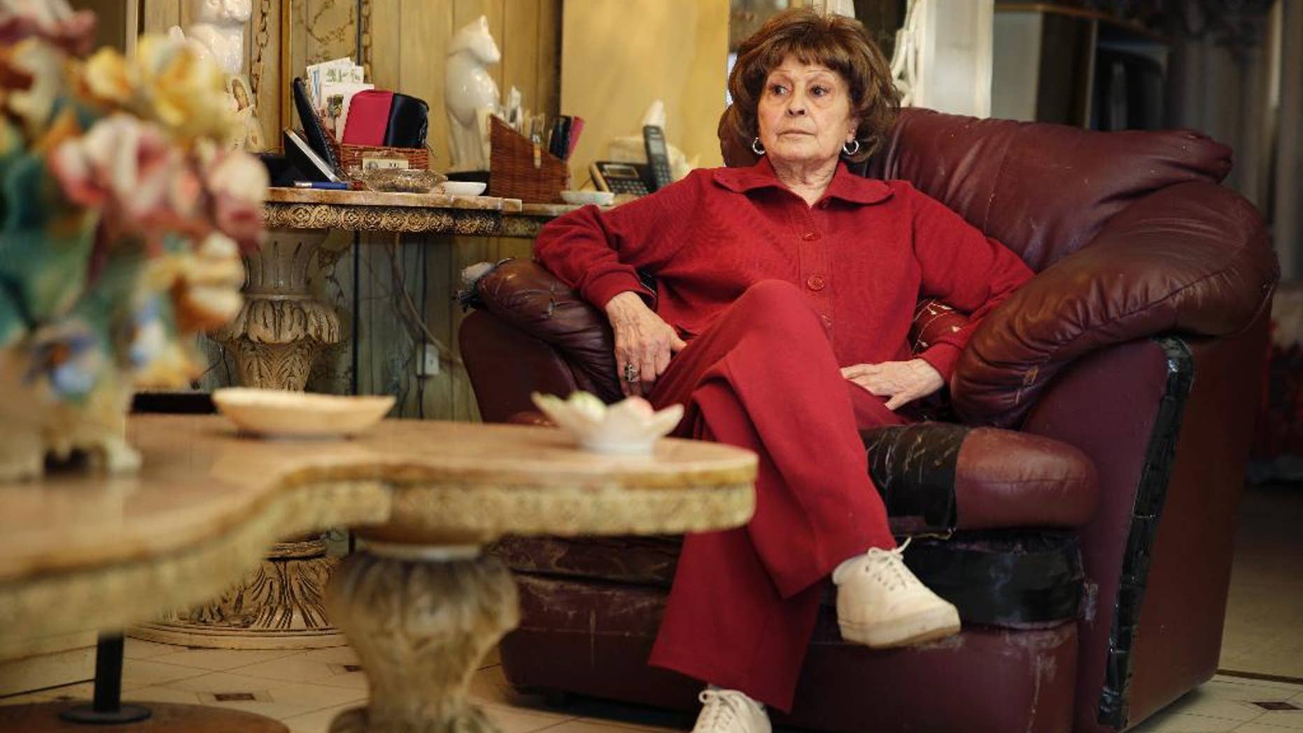 FILE - In this Tuesday, March 31, 2015, file photo, Adele Sarno poses for a picture in her apartment in the Little Italy section of Manhattan, in New York. Sarno, who faces eviction from her apartment, has until June 30 to leave under an agreement reached with her landlord, the Italian American Museum. Sarno has lived in the same 2-bedroom apartment over the museum for more than 50 years. (AP Photo/Seth Wenig, File)