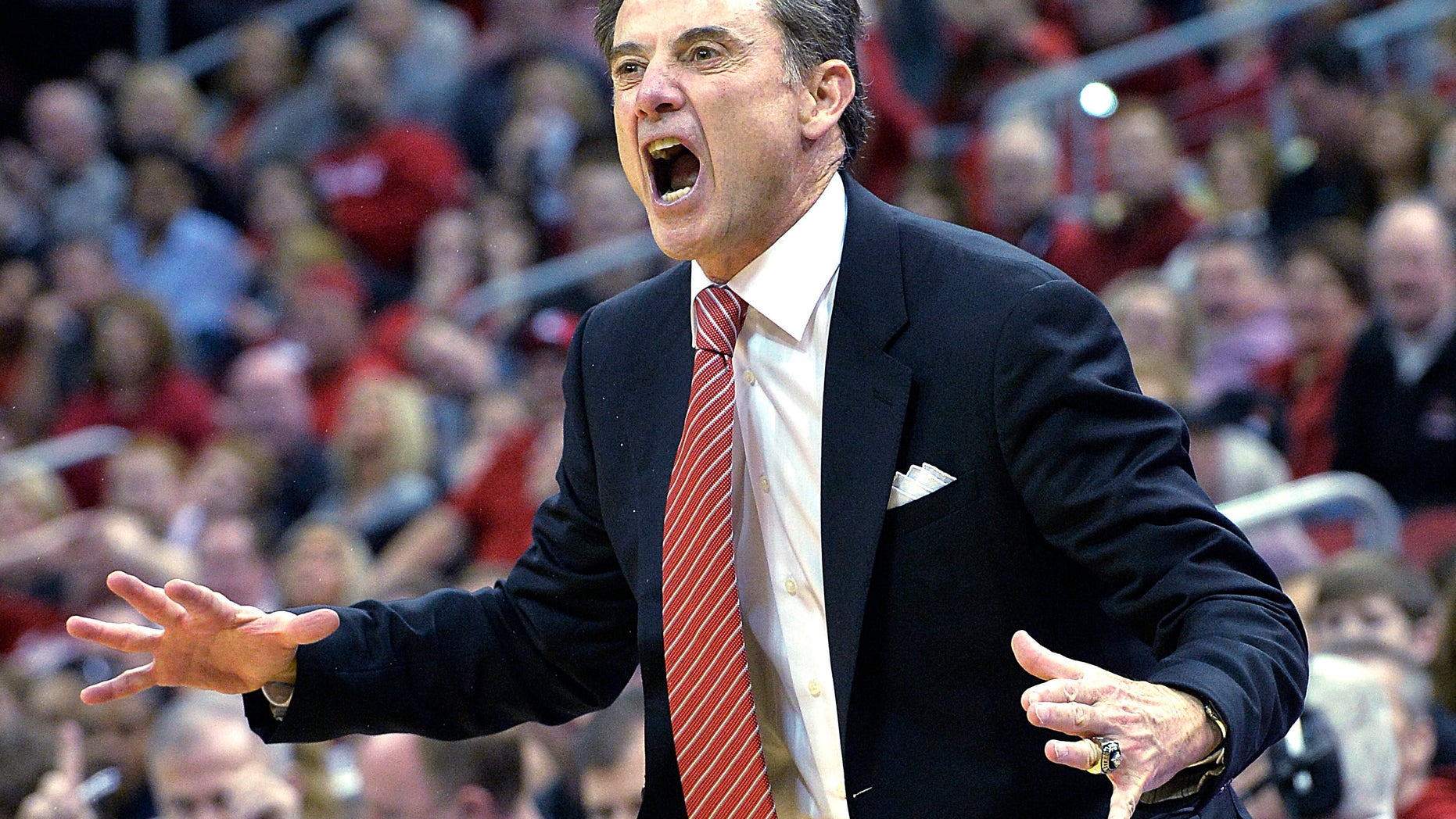 Louisville's head coach Rick Pitino shouts instructions to his team during the first half of an NCAA college basketball game Sunday Jan. 12, 2014, in Louisville, Ky. (AP Photo/Timothy D. Easley)