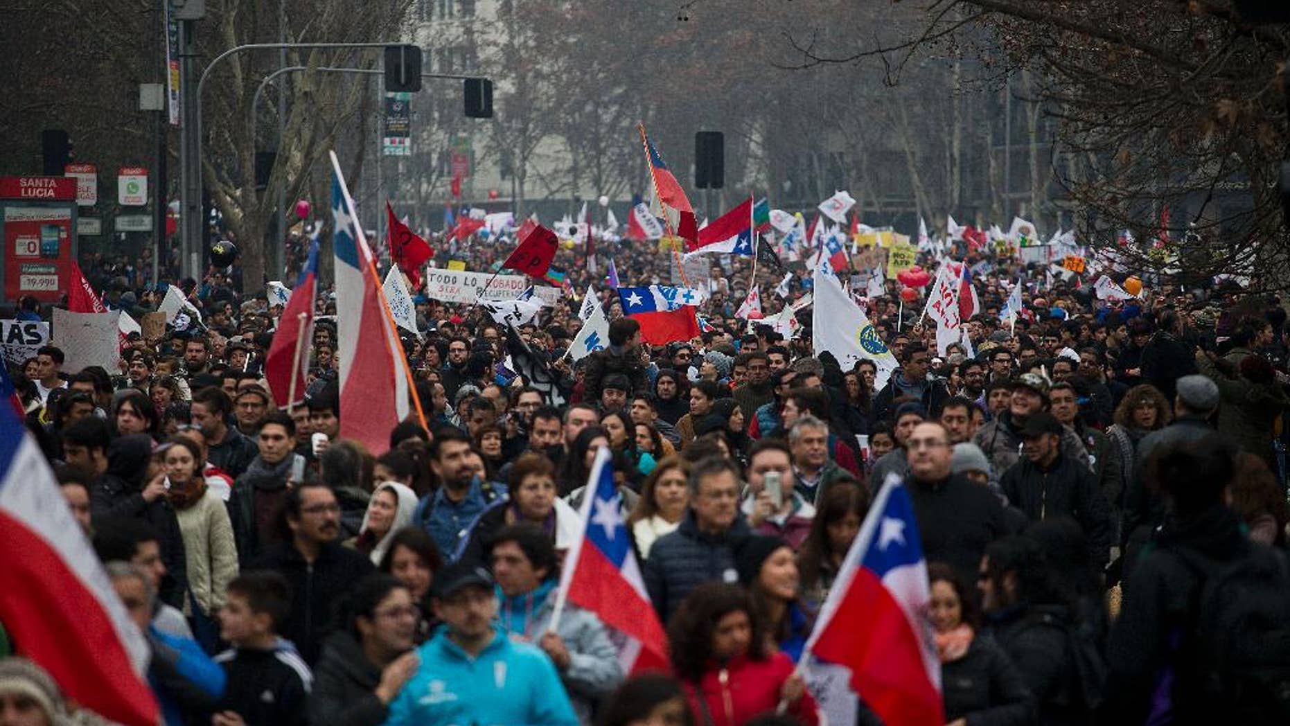 Thousands of workers march against the Pension Fund Administrators demanding an end to the system due to low pensions, in Santiago, Chile, Sunday, July 24, 2016. There were demonstrations and marches in several other cities in the conuntry. (AP Photo/Esteban Felix)
