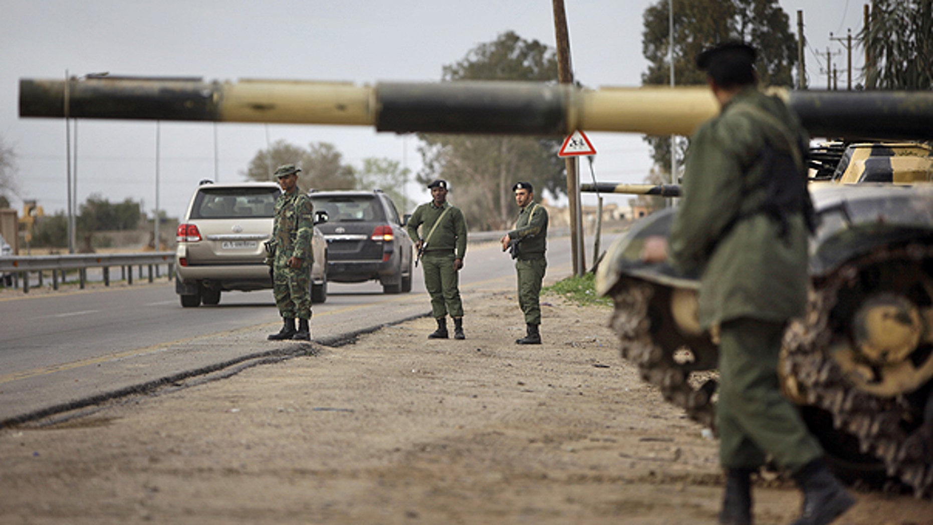 Feb. 28: Soldiers and dozens of tanks from the Libyan military's elite Khamis Brigade, led by Qaddafi youngest son Khamis Qaddafi take positions and check vehicles after arriving hours earlier on the road in Harshan, 10km east of Zawiya, in Libya.